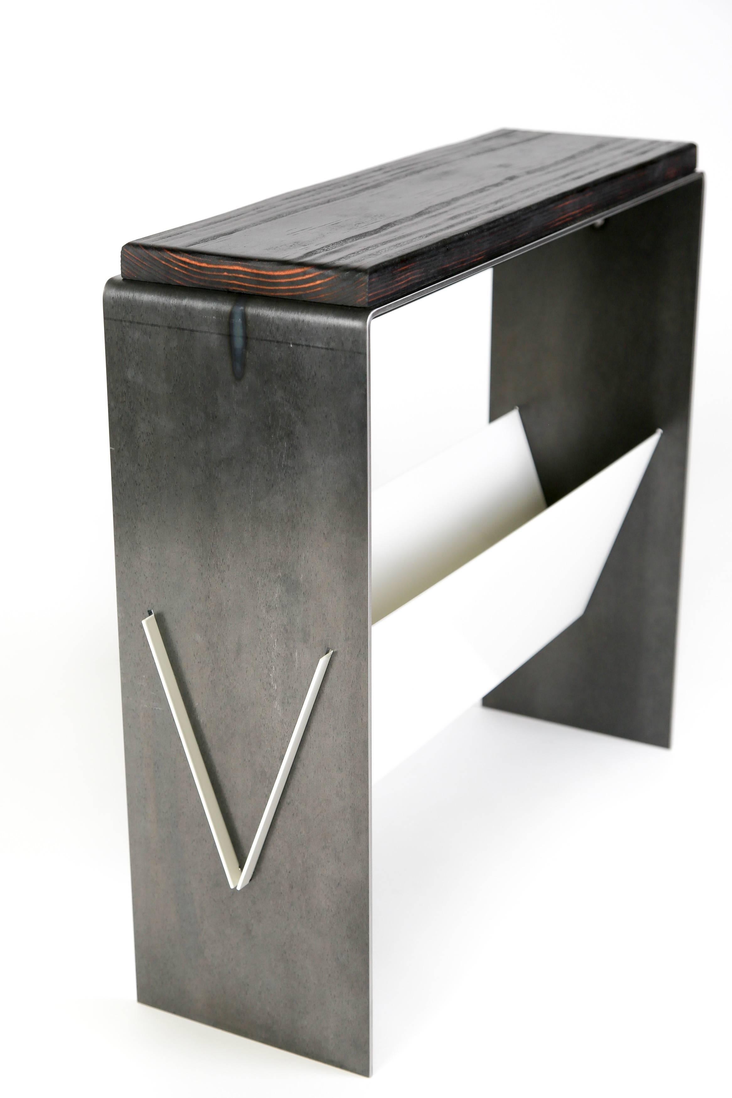 This simple side table or end table brings a modern aesthetic of simplicity and cleanliness. A versatile table that can be used as a side table, end table, or cocktail table allows for magazine or book storage below in a sleek niche. Available in