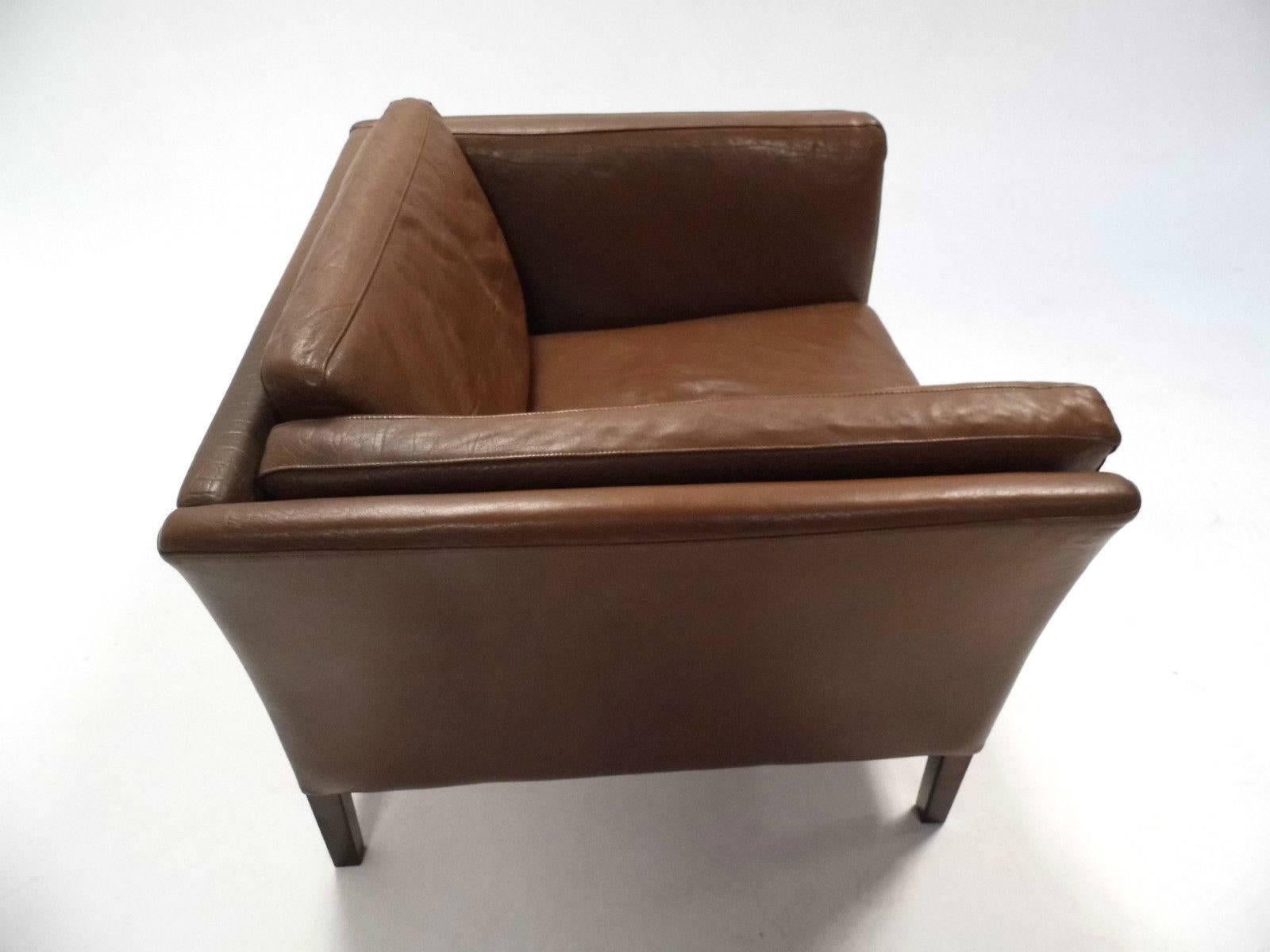 A beautiful Danish brown leather armchair, this would make a stylish addition to any living or work area. The chair has a wide seat pad and padded armrests for enhanced comfort. A striking piece of classically designed Scandinavian furniture.

The