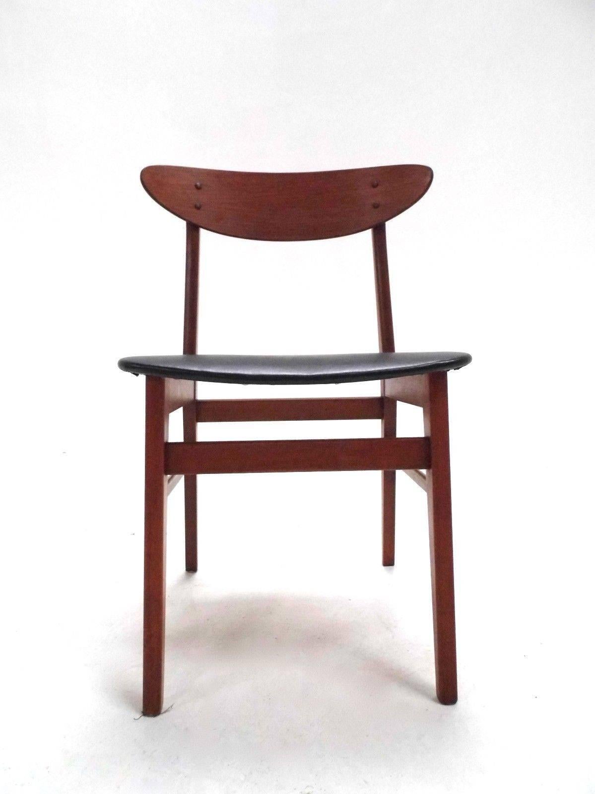A beautiful Danish set of four teak dining chairs by Farstrup, this would make a stylish addition to any dining area. The chairs have wide seat pads and curved backrests for enhanced comfort. A striking piece of classically designed Scandinavian