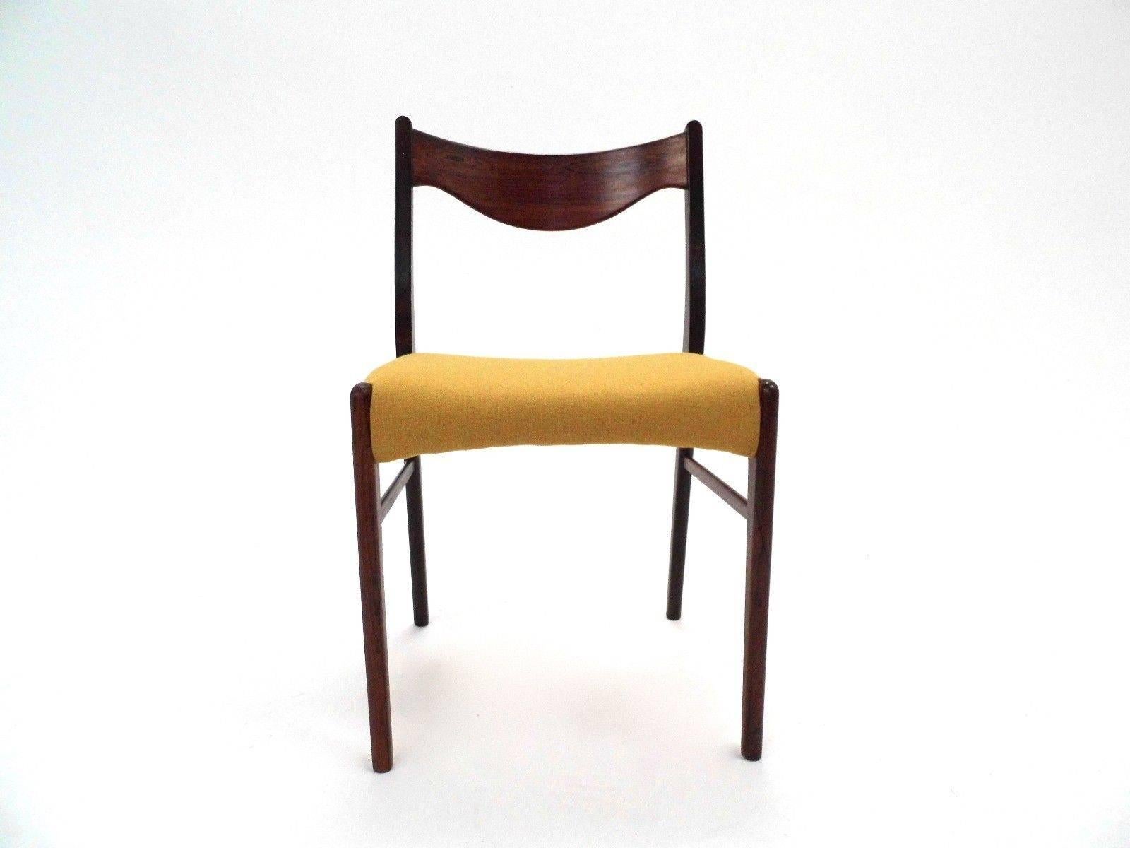 A beautiful set of six Danish rosewood and yellow wool dining chairs, these would make a stylish addition to any dining area. The chairs have wide seat pads and sculptured rosewood back rests. A striking piece of classically designed Scandinavian