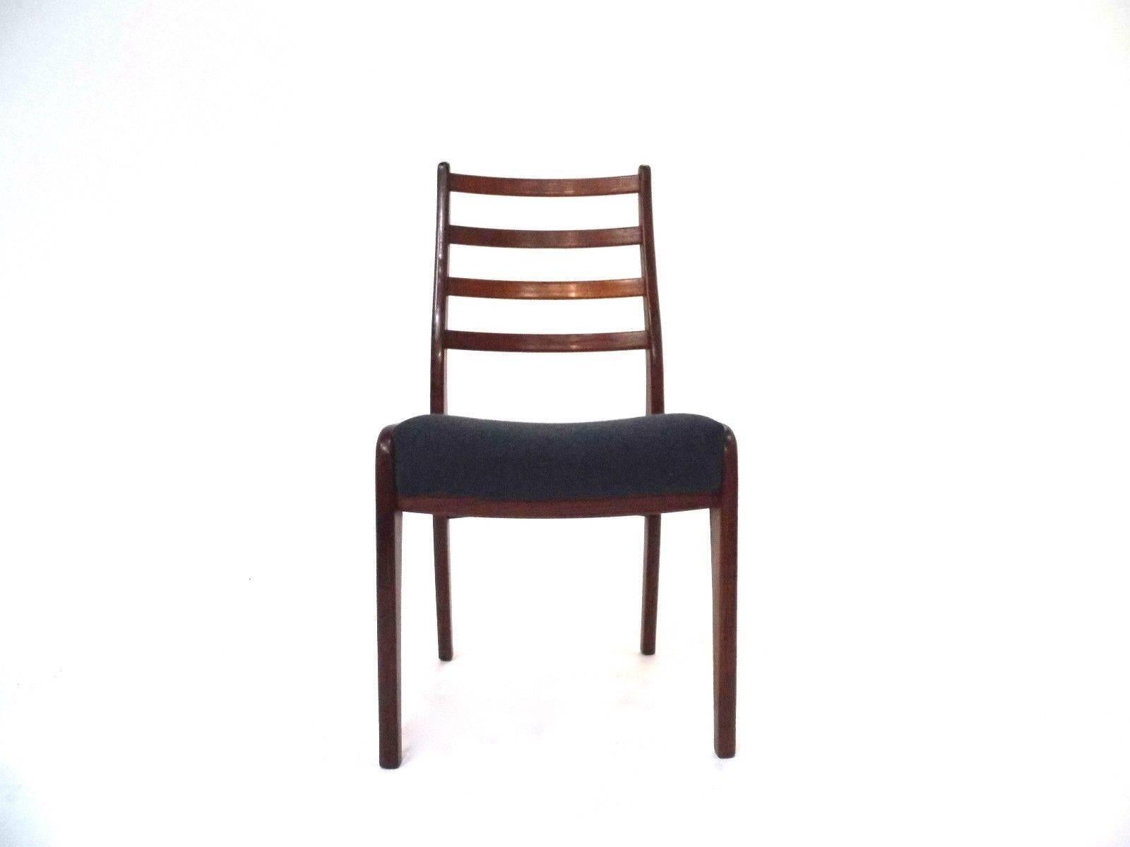 A beautiful set of four G Plan teak and blue wool dining chairs, these would make a stylish addition to any dining area. The chairs have wide sculptured seat pads and high teak back rests. A striking piece of classically designed midcentury