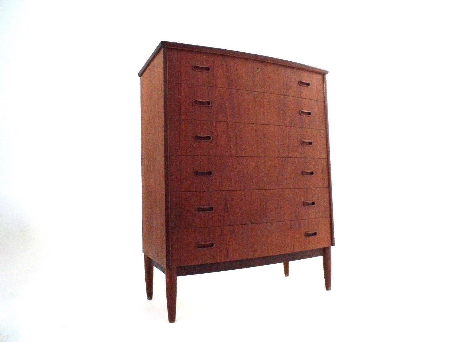 A beautiful Danish teak tallboy chest of drawers with a bowed front, this would make a stylish addition to any bedroom area. The chest has six drawers, all are in good working order with sculptured wooden handles and dovetail joins. A striking piece