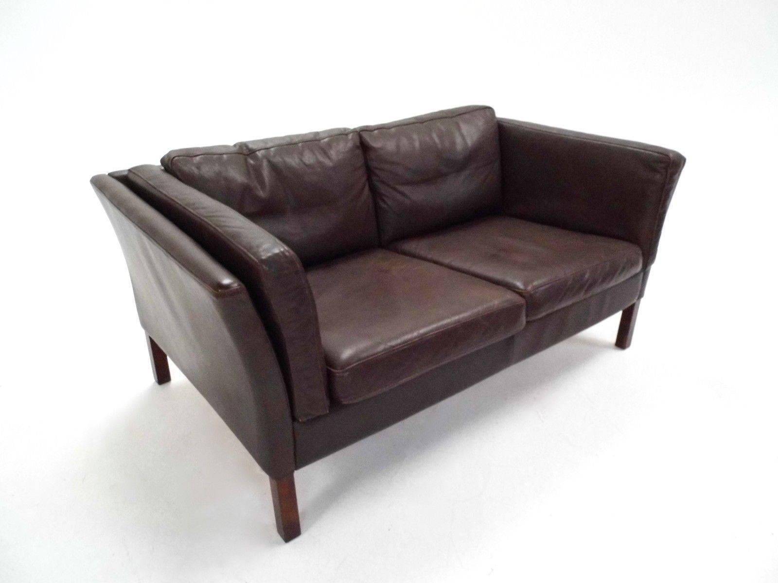 A beautiful Danish brown leather two-seat sofa, this would make a stylish addition to any living or work area. The sofa has wide cushions and sculptured padded armrests for enhanced comfort. A striking piece of classic Scandinavian furniture.

The