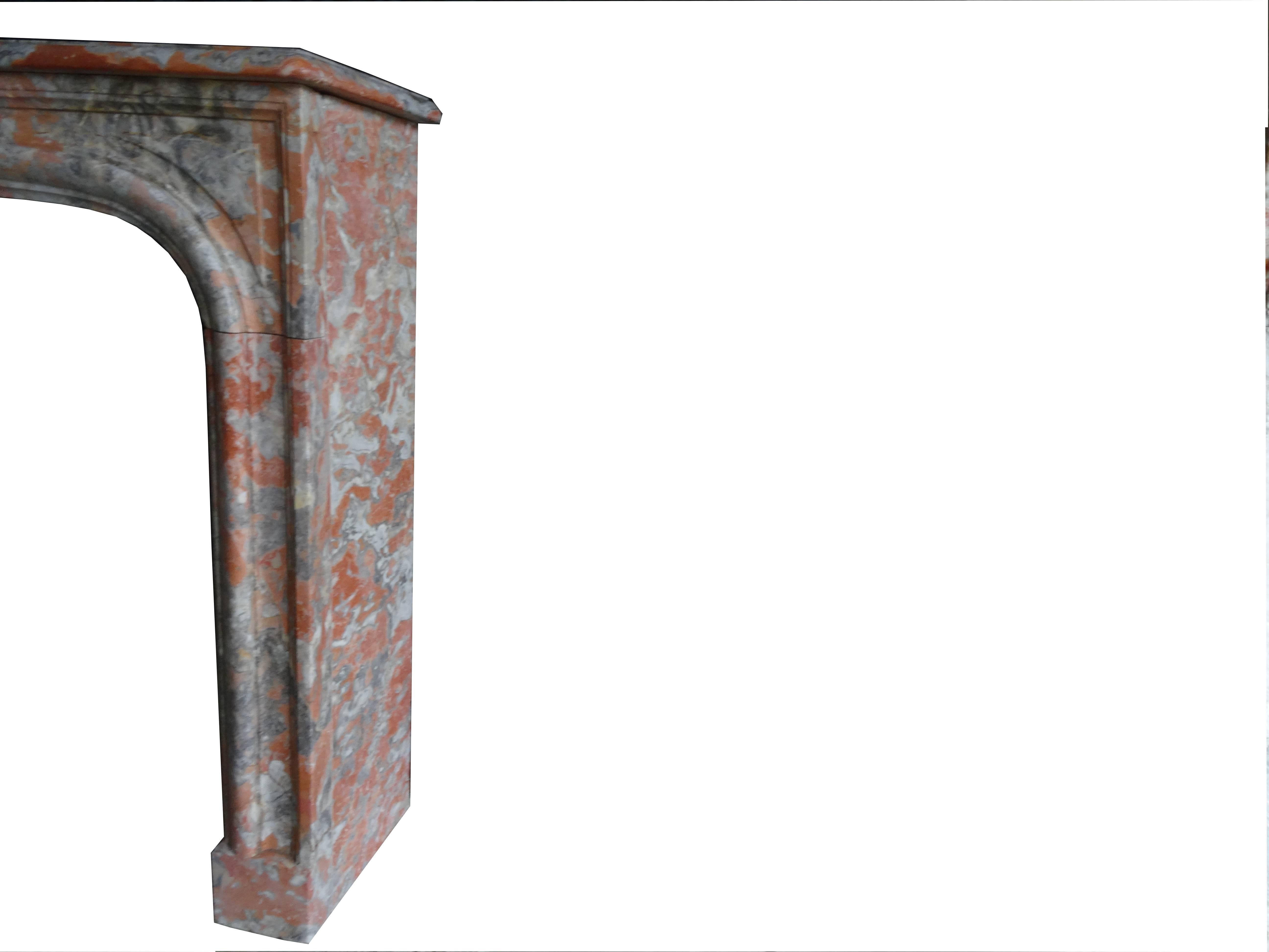 19th century antique Louis XIV style fireplace made of red incarnat marble. This marble is quite similar to the red Languedoc marble, but has a more light colored hue with contrasting elements. The tablet has a beautiful character and patine.