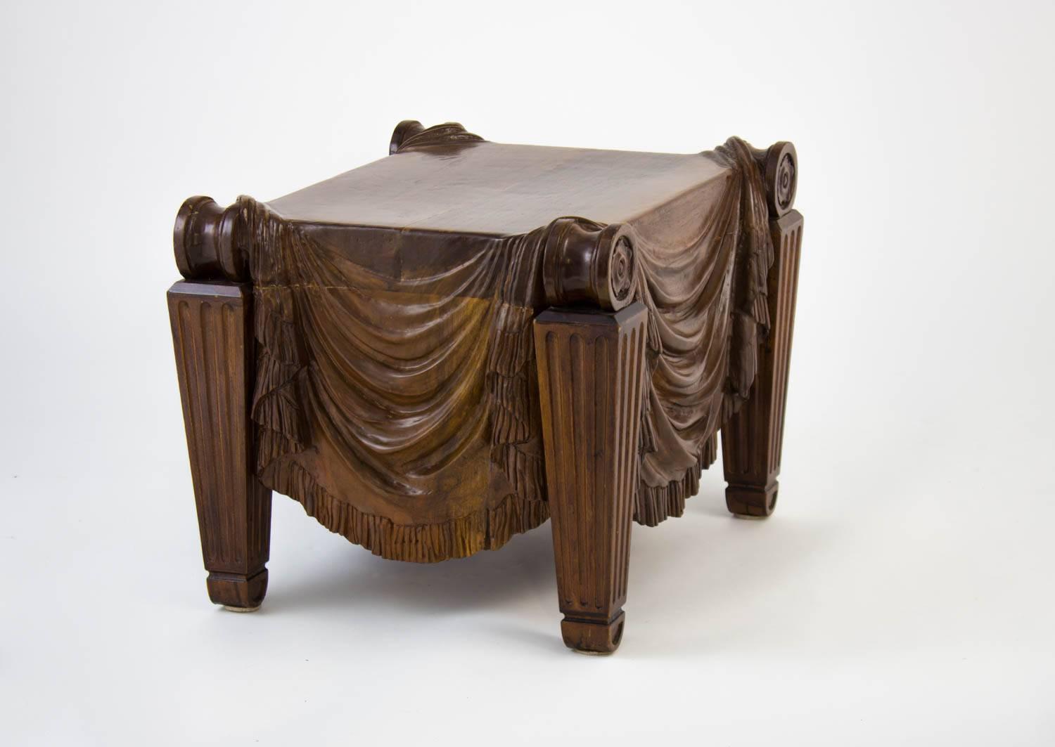 An intricately carved drapery swaging to scrolls on each edge over fluted, tapered legs. Solid wood, an original prototype hand-carved by a local woodworker. This design was produced in more production later by Ralph Lauren. 