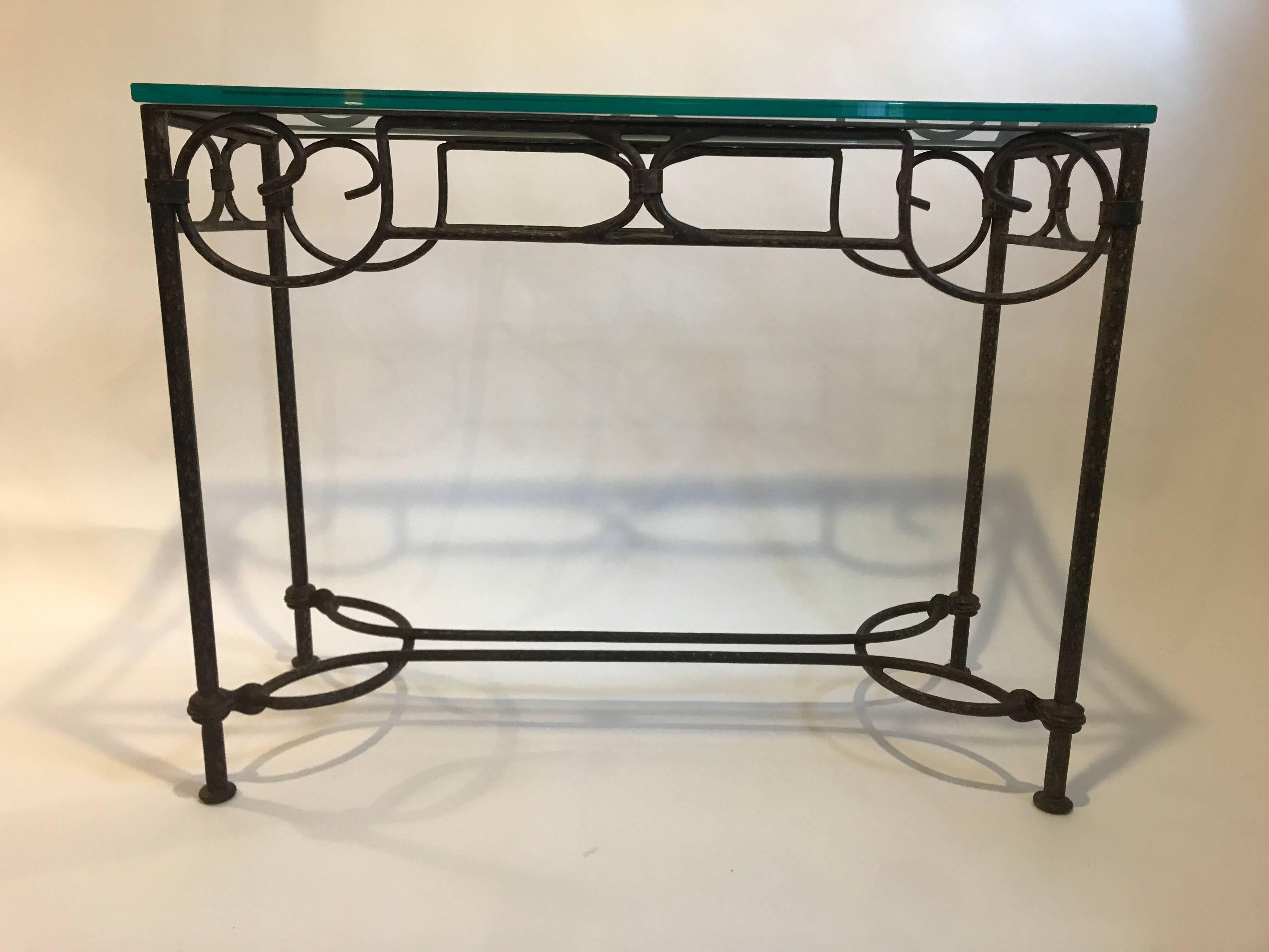 Wrought iron console table with scrolling detailing and a 3/4" thick glass top.
 