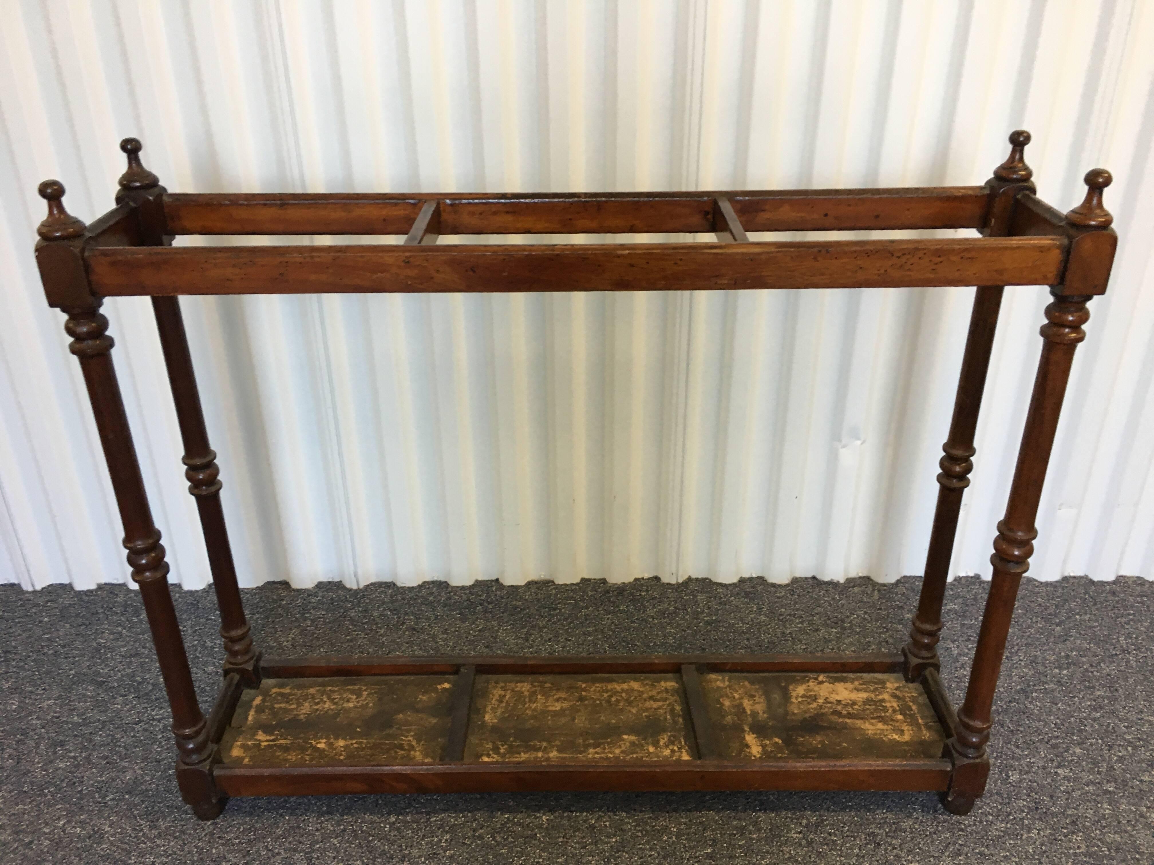 English Victorian rectangular stick umbrella hall stand. Made in solid turned wood with finials and three dividers.