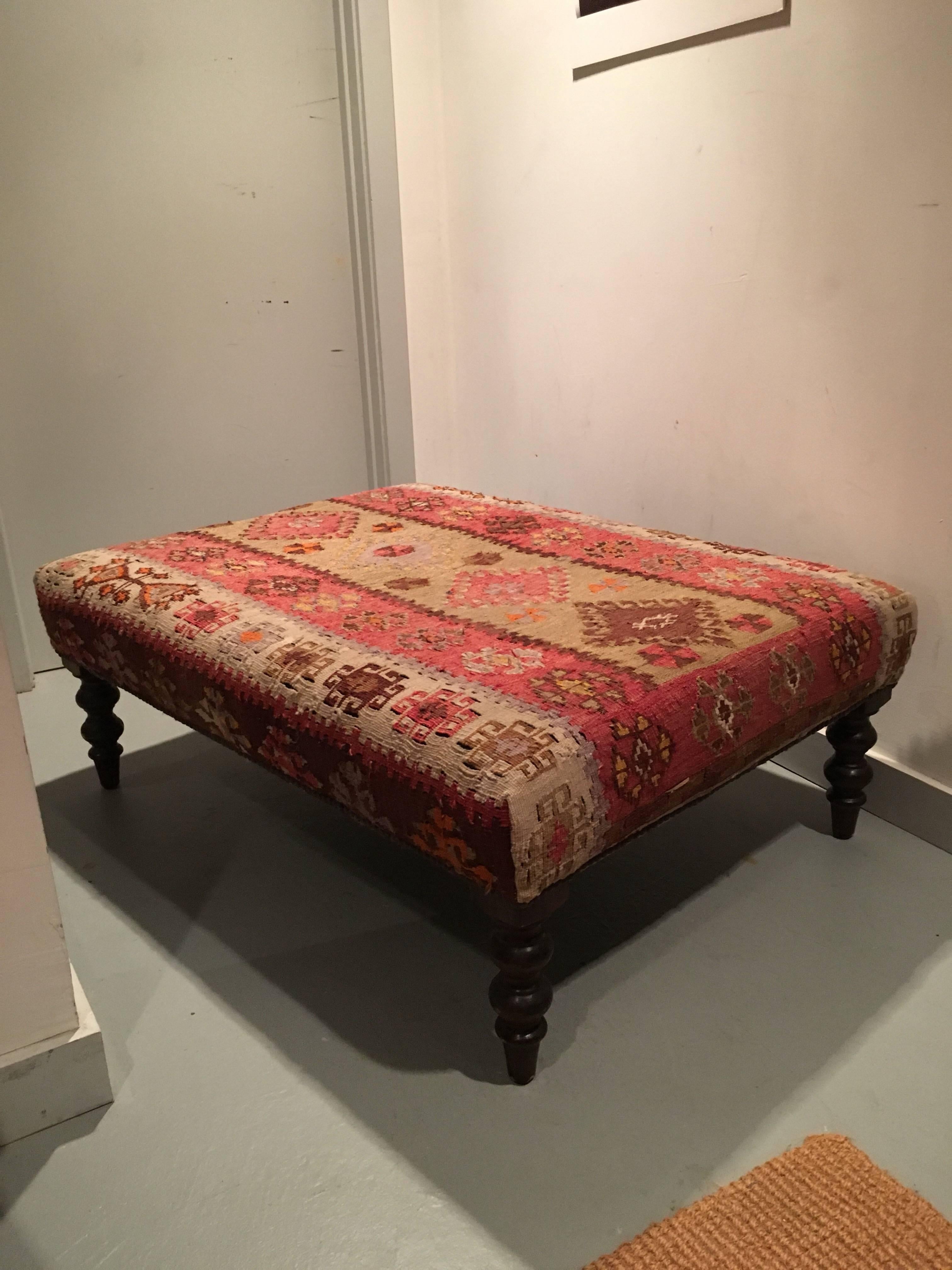 Kilim upholstered rectangular ottoman, thought to be purchased at George Smith 28 years ago, however, not marked. Brass nail heads applied around perimeter of ottoman sitting atop dark carved turned legs.

Excellent condition for age and use.

 