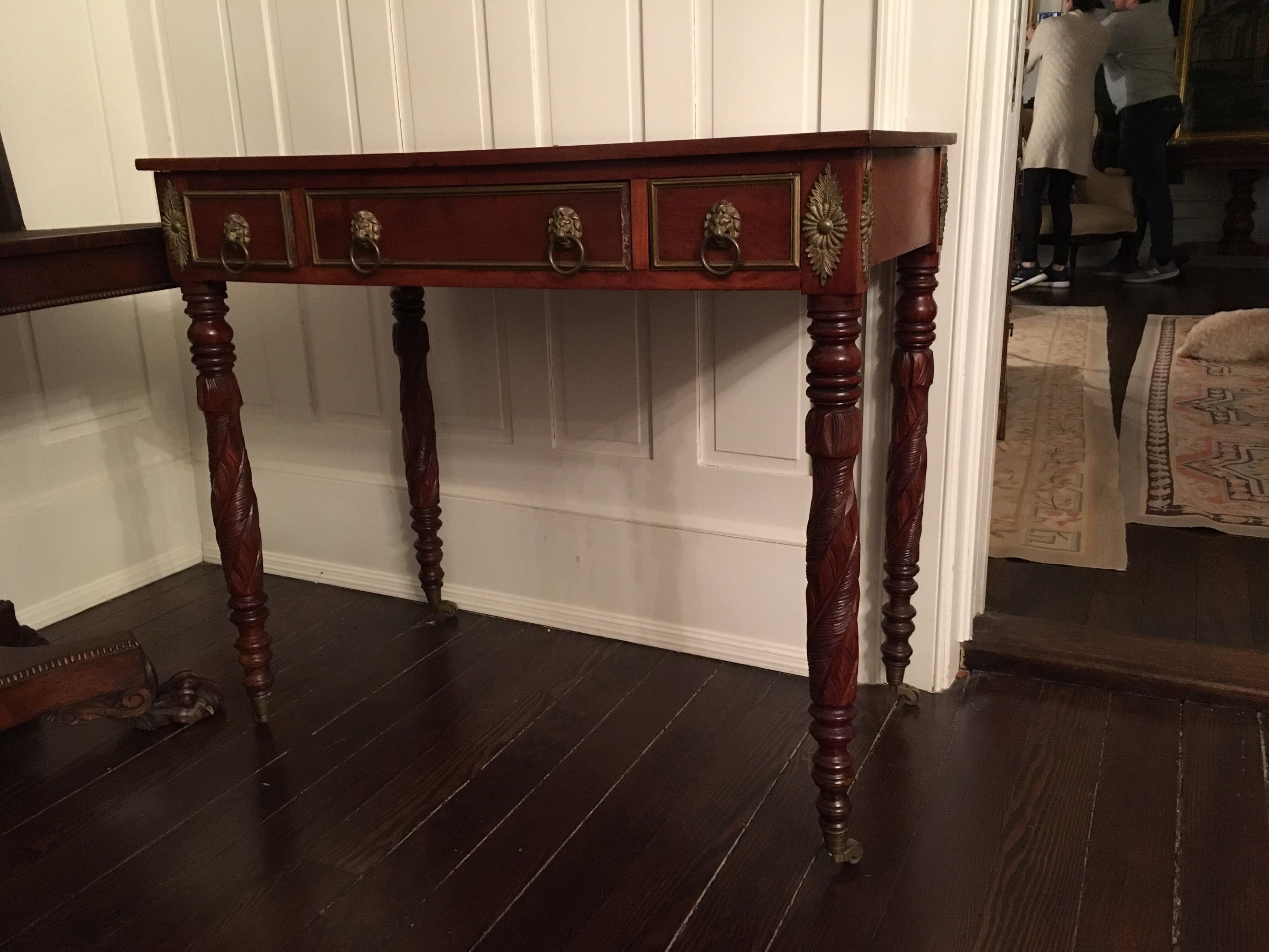 American empire writing table with carved acanthus legs, circa 1840
Casters, Missing ormolu on right side of centre drawer. Beautiful ornately carved acanthus legs with casters with heavy ormolu detailing around drawers.

25