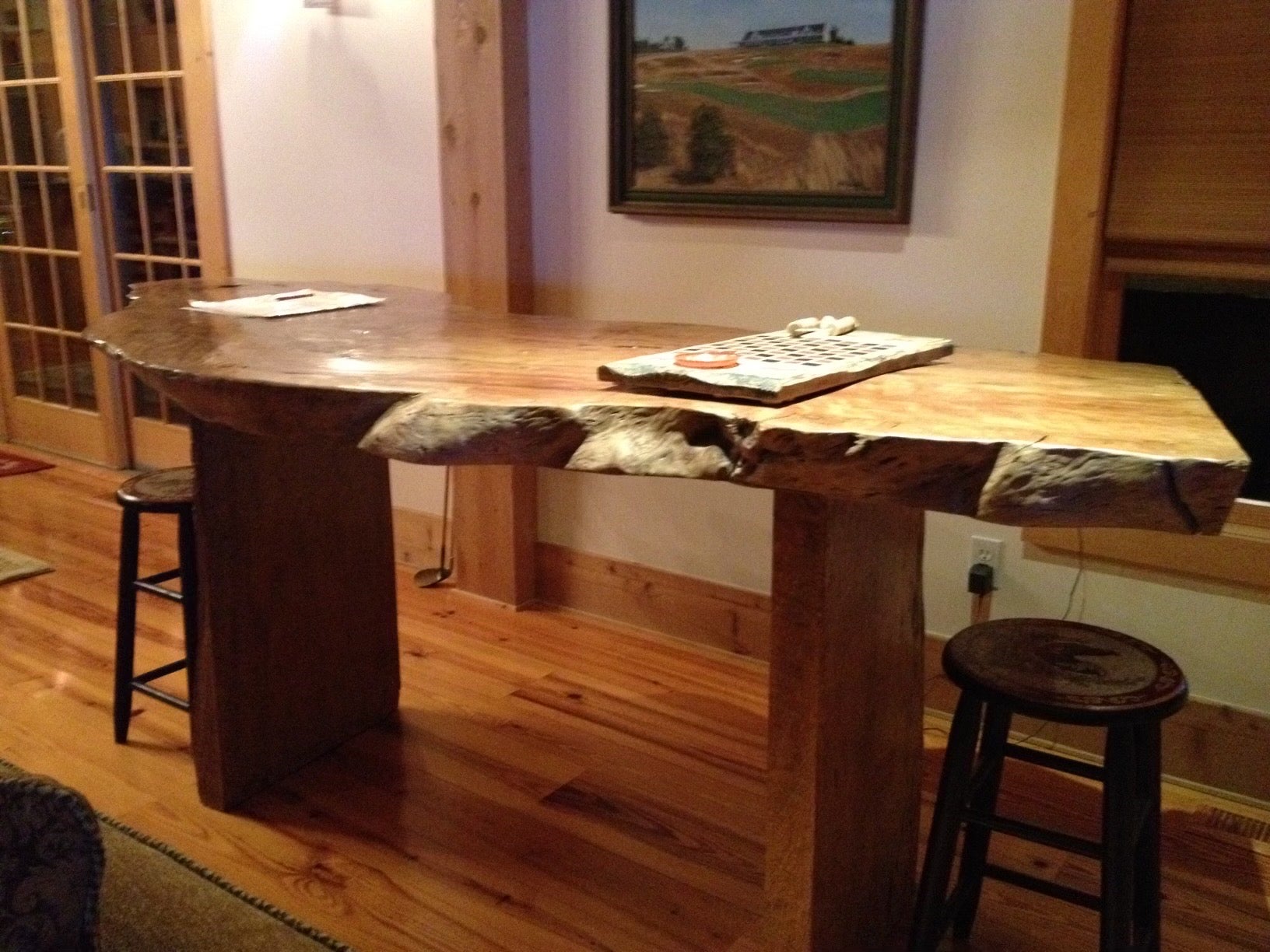 Cette magnifique table de salle à manger en noyer, de style Nakashima, est dotée d'un superbe plateau en dalles de 3,75 pouces d'épaisseur avec des arêtes vives sur les quatre côtés. Monté sur deux solides morceaux de bois avec écorce exposée sur le