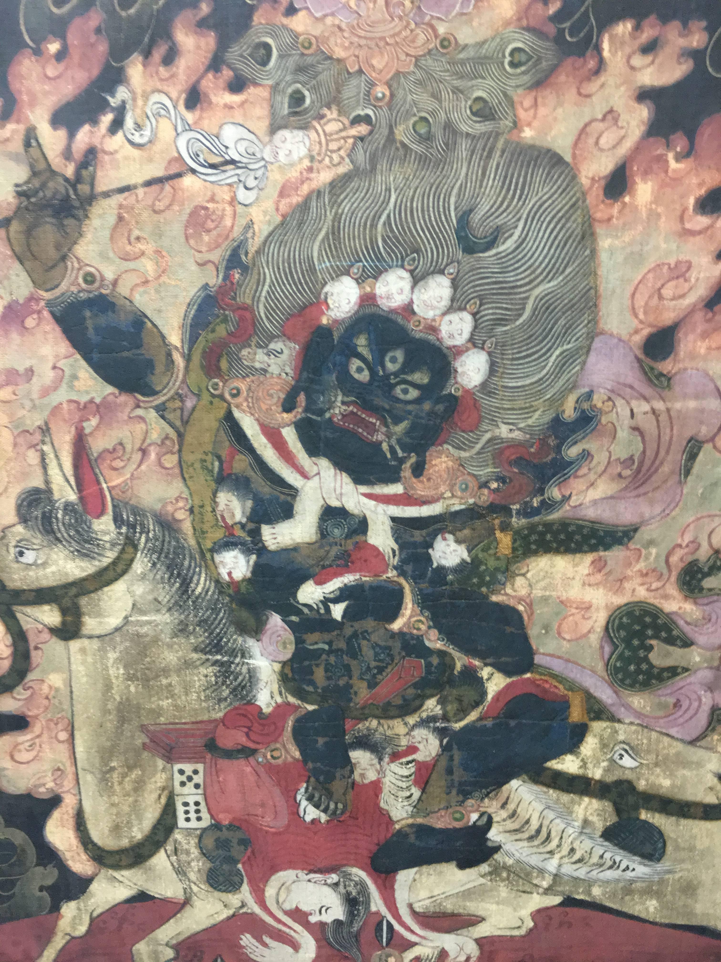 A painting of Shri Devi Magzor Gyalmo Tibet, 18th century.
The blue skinned goddess seated on her mule, holding a skull cup and an incense stick aloft, wearing various skull garlands and animal heads.
Measures: 50