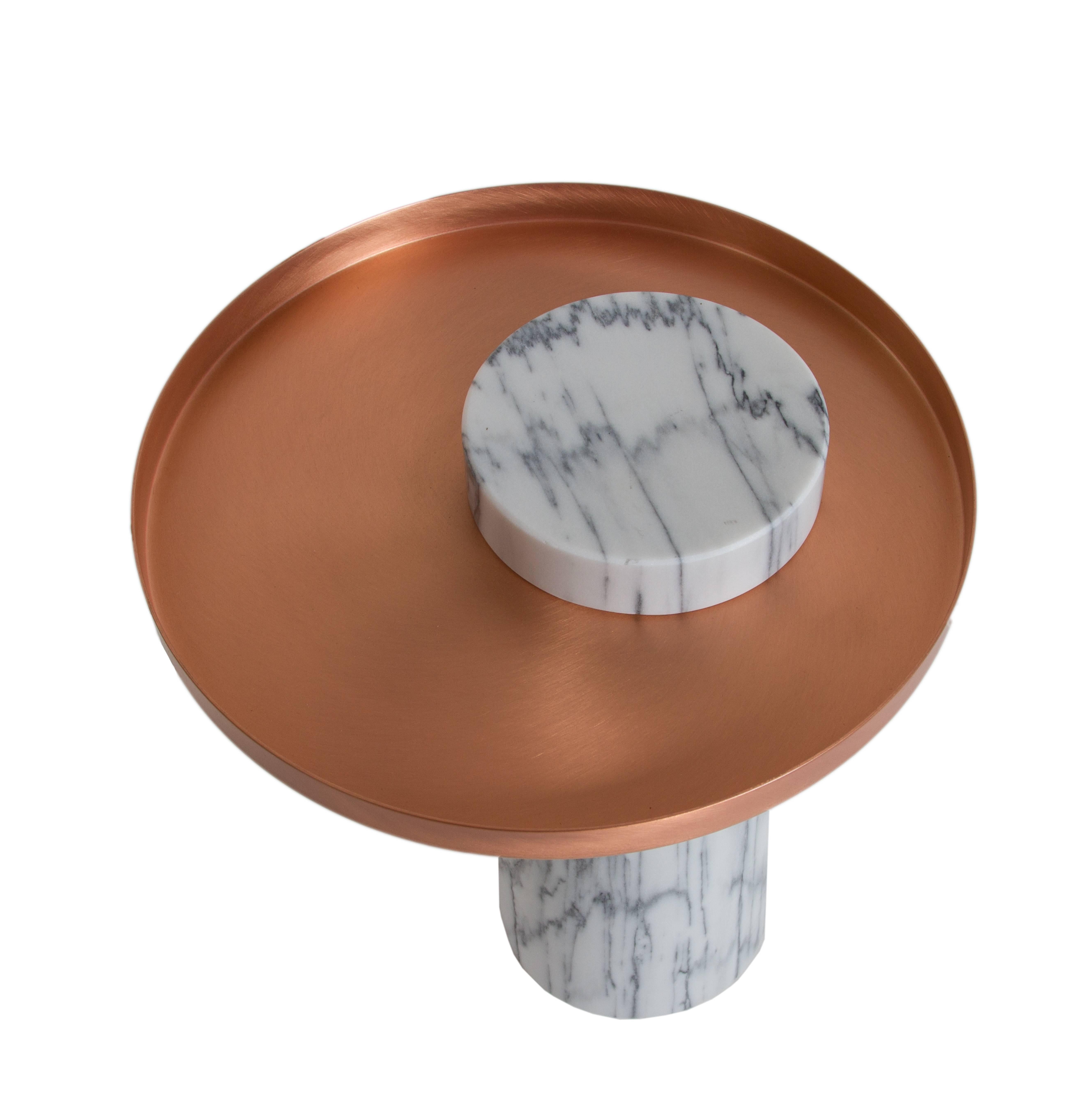 'Salute' marble and copper side table by designer, Sebastian Herkner, manufactured by La Chance. 
White pele de tigre marble column and copper tray,
2015.
Measures: 16 1/2” height x 15 1/2” diameter.