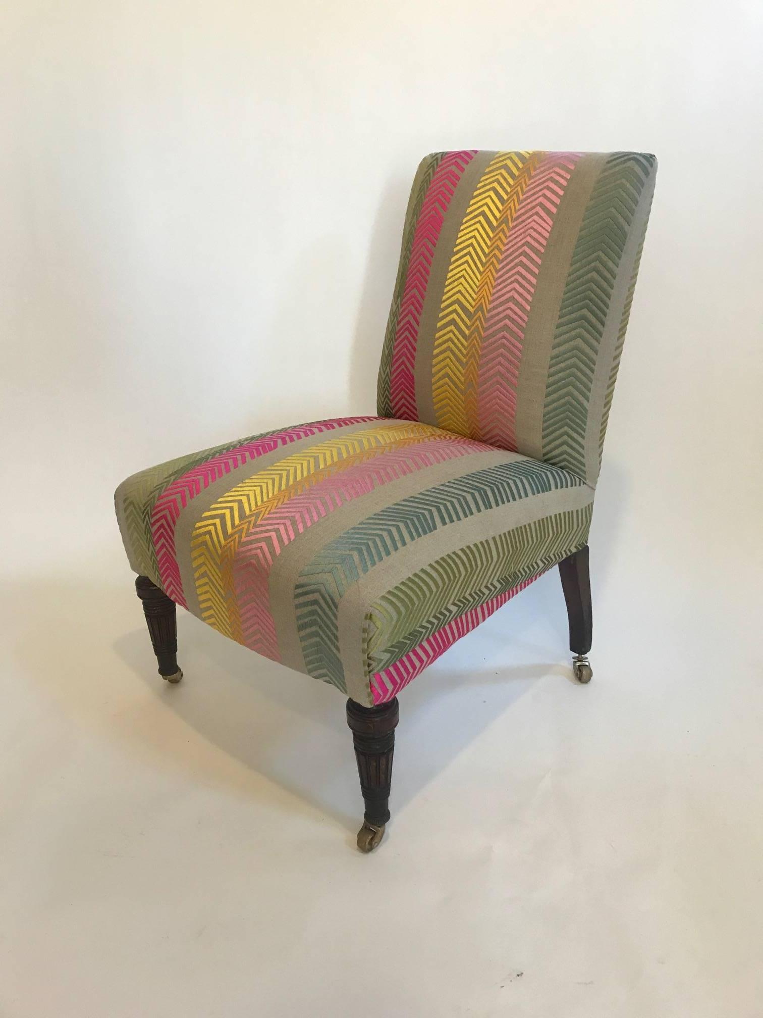 Early 20th century English square back side chair reupholstered in Christopher farr, bookend, fabric designed by Kit Kemp.
Back side of chair is upholstered in sage linen and features brass nail heads around perimeter of back. Legs on casters.