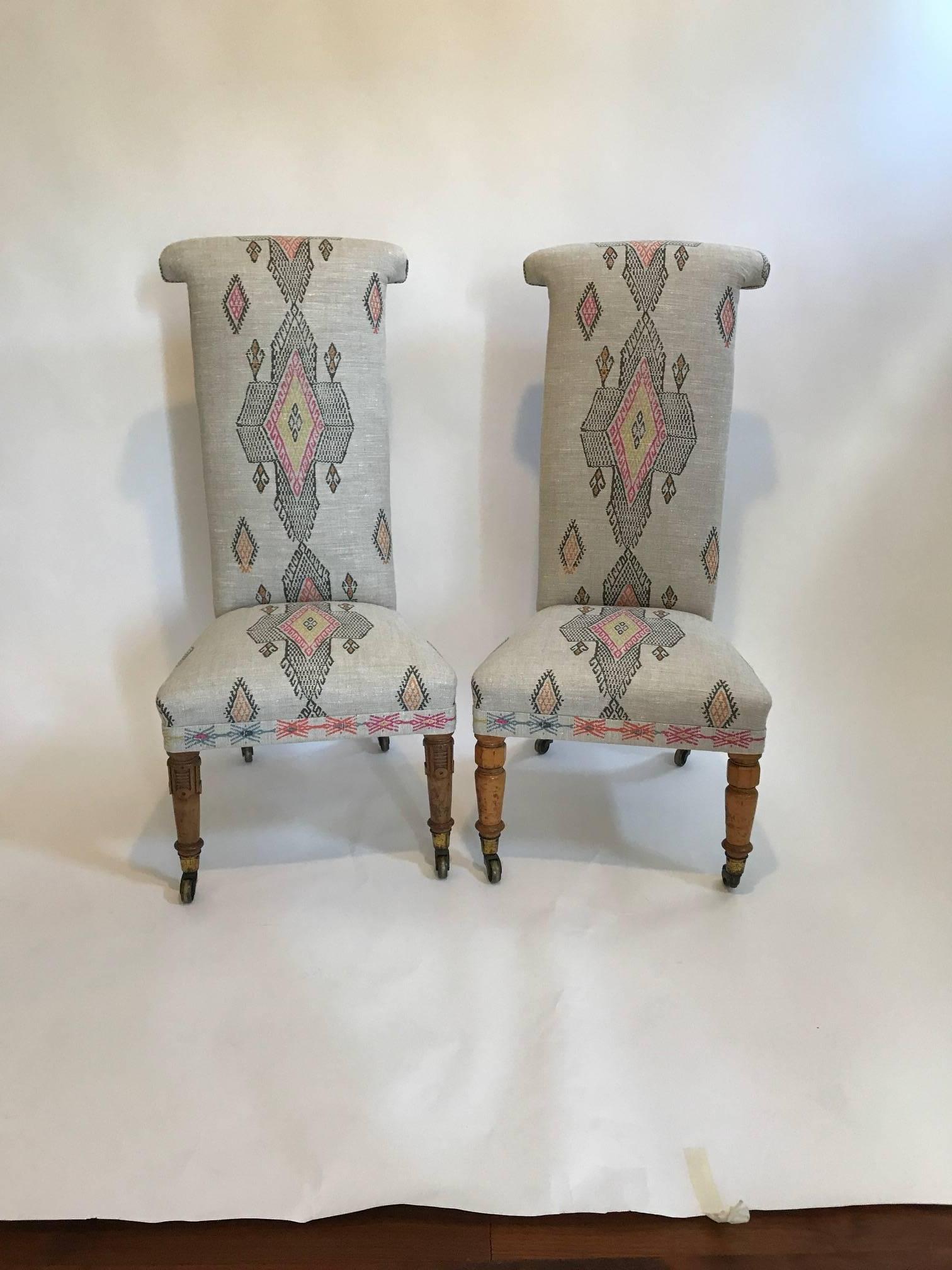 20th century English Victorian tall back nursing chairs reupholstered in Christopher Farr fabric, Traveling light, designed by Kit Kemp.
Backs of the chairs are covered in a dark brown linen with polished nickel nailheads around perimeter of