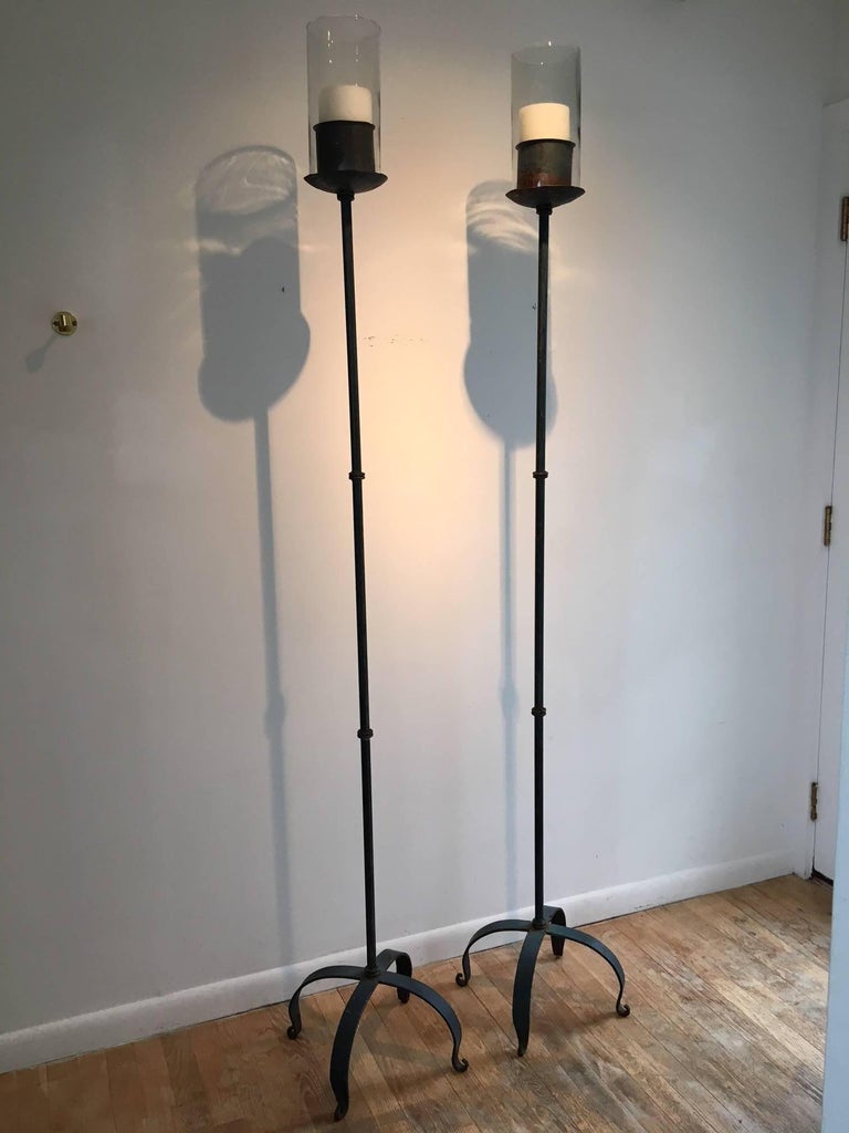Pair of 19th century, French iron candle torchéres. Two pair available. Simple curved X base design with glass shade. Great patina of old green paint with some rusted areas.
Measures: 79.5