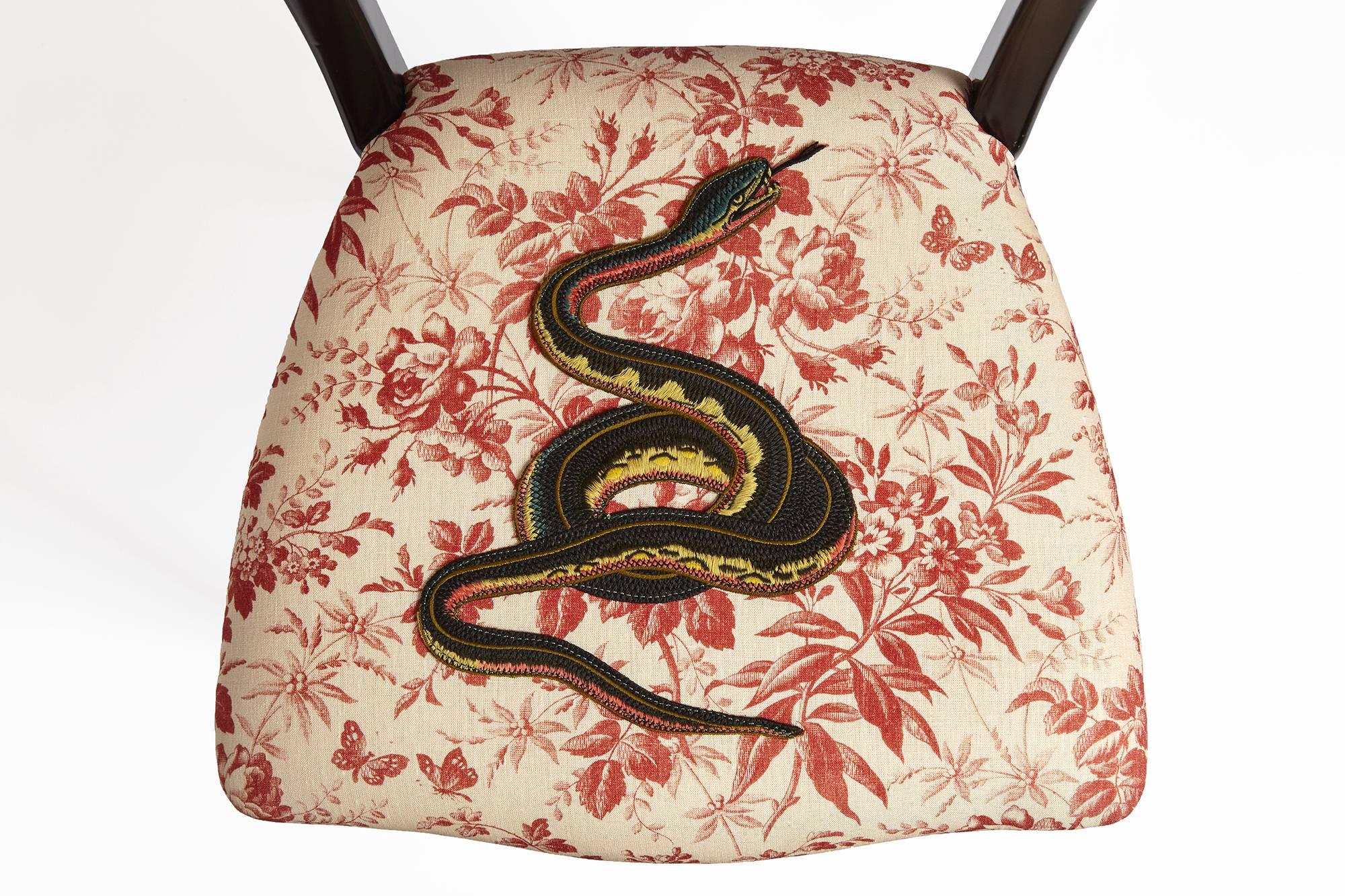 One of a kind Gucci chair. Semi gloss black lacquered wooden frame, padded seat upholstered in 100% linen canvas in red/black herbarium pattern, with different embroidery for each chair, with a colored grosgrain edging mounted with an antique
