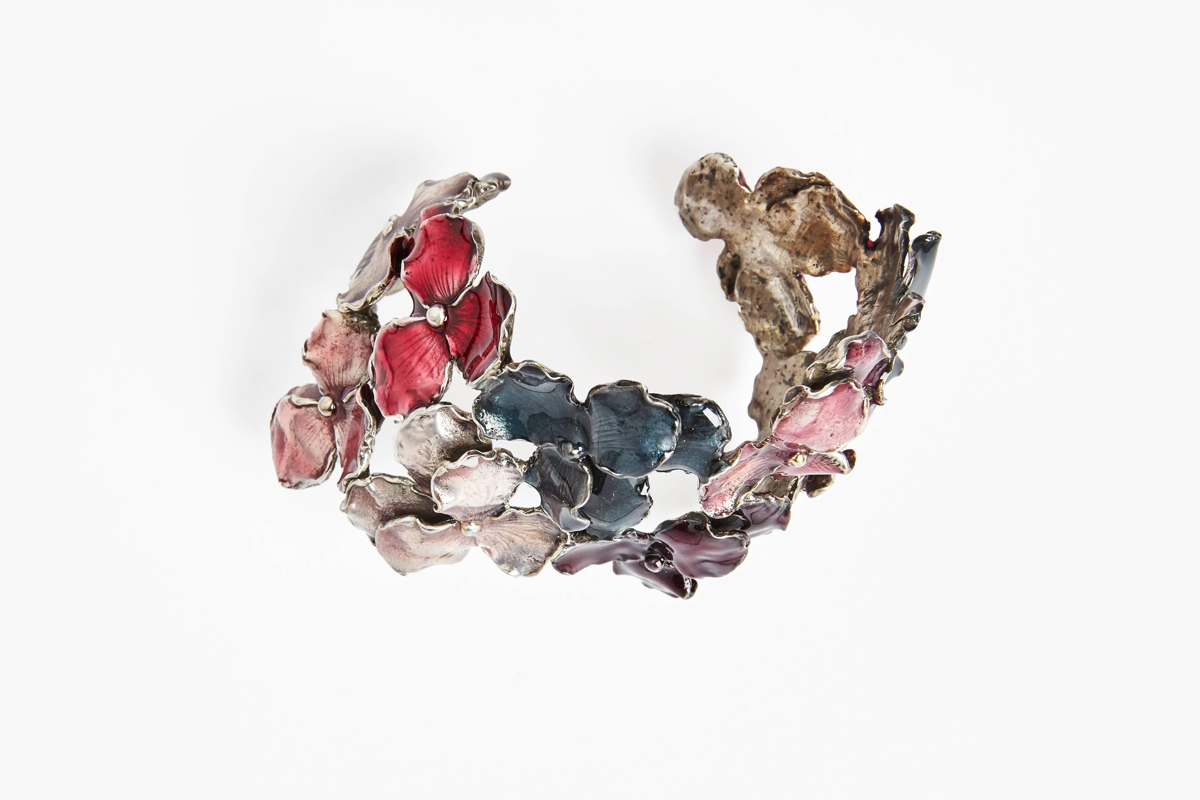 The Panze bracelet by Osanna and Madina Visconti. Brass Silver plated bracelet filled with different colors of enamel. Handcrafted in Italy by Osanna and Madina Visconti di Modrone. 

Fits beautifully and can be adjusted on the wrist.