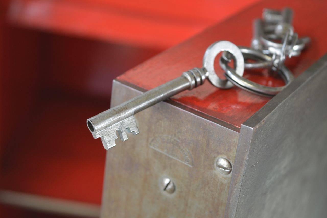 This French antique cast iron safe was made by Gauthier manufactory. 
 It comes with the originals keys and is fully functional. 
The rosette on the left hides the key hole and the one on the right is decoration.
 The red color inside is not