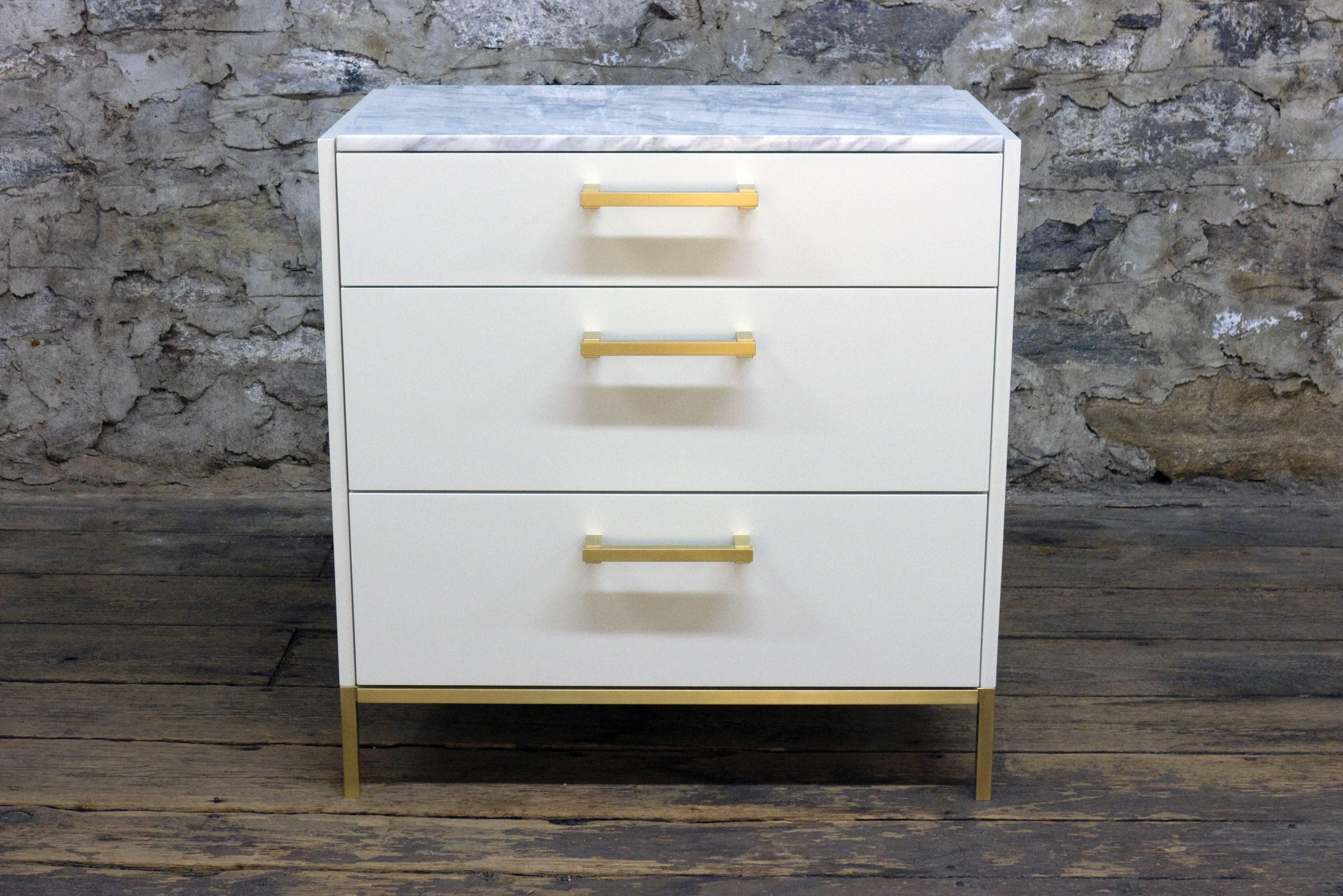 Shown in satin white lacquer with burnished brass hardware and Calcatta marble, the Moreno bedside chest features three solid wood drawers with under-mount drawer slides, custom-made hardware and a solid brass base.
Dimensions (as pictured): 32