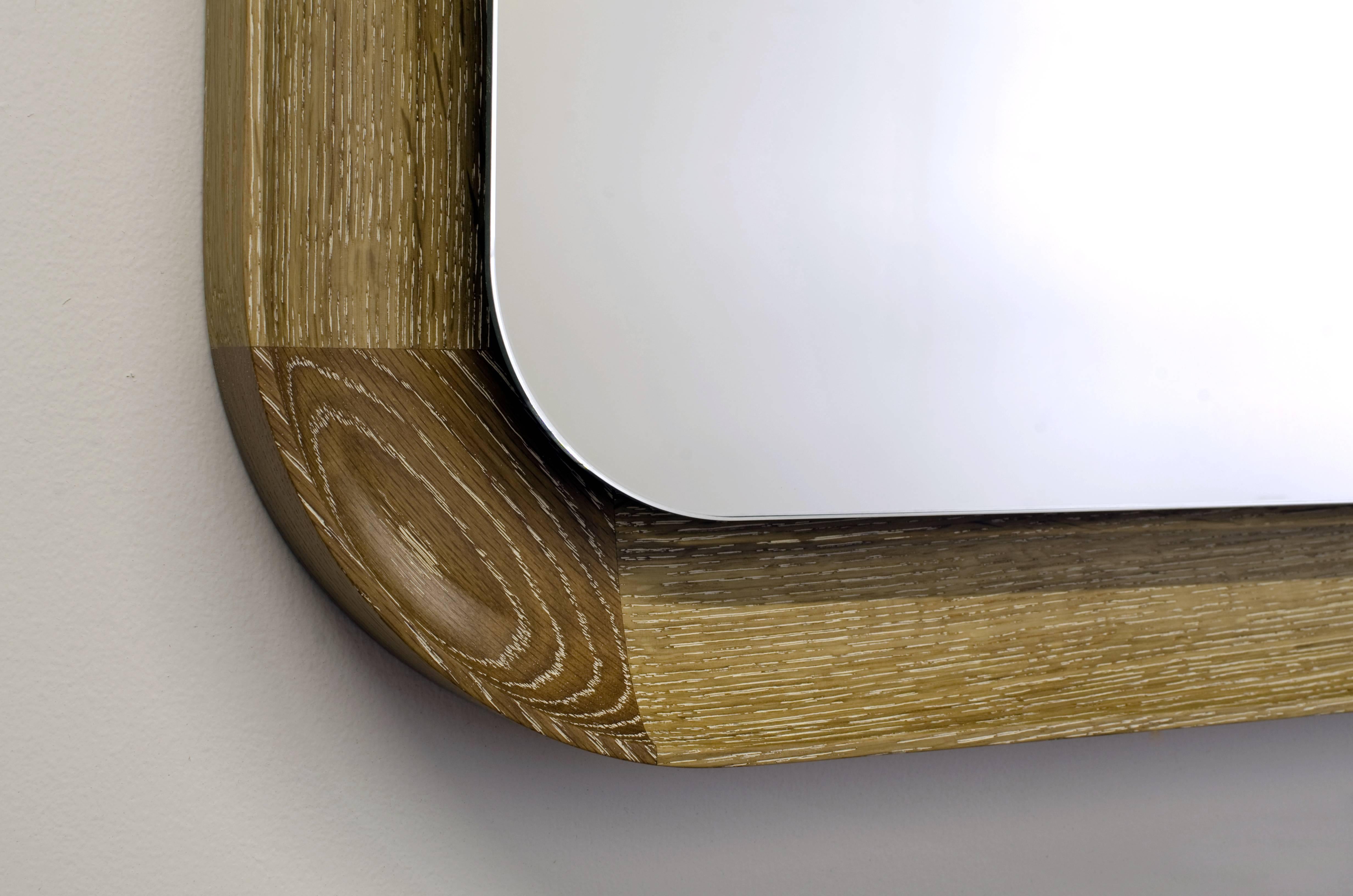 Rectangular Covina mirror pictured here in cerused white oak, featuring a carved solid wood frame which returns behind a pane of floating low-iron mirror.
Dimensions (as pictured): 25-1/2