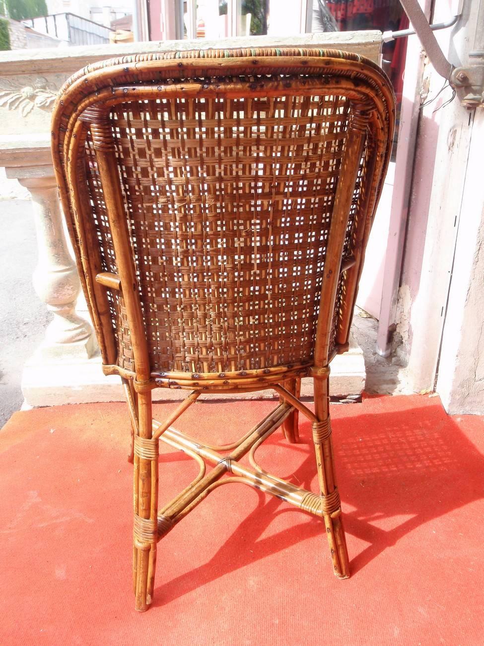 Beautiful natural rattan chair with green stripes. 

The rattan furniture is perfectly suited for refined interiors, verandas or other winter gardens. This new space, generally located in front of the house, extends the living room and the dining