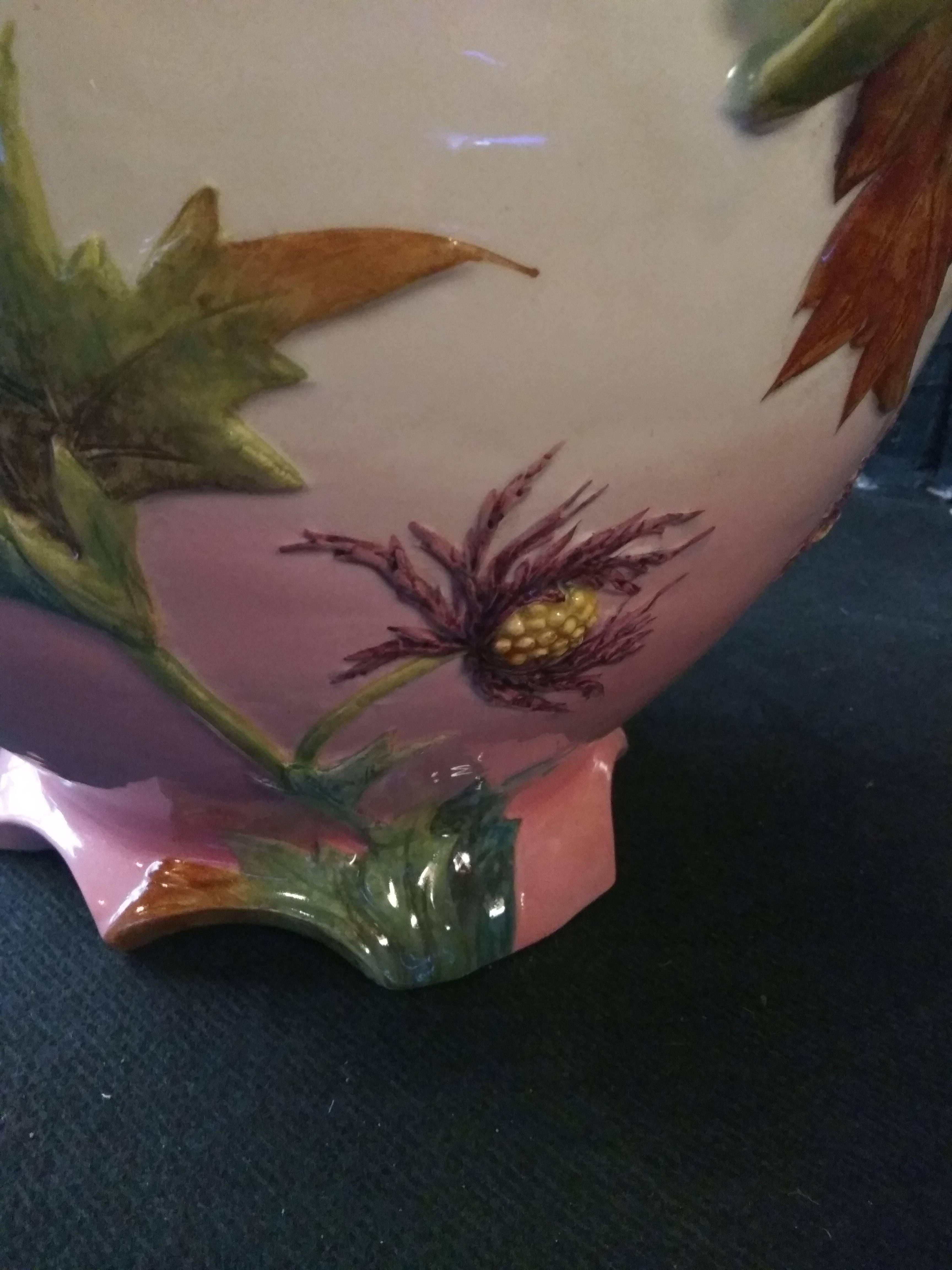 This beautiful planter with thistles is a reminiscent of the Mediterranean majolica tradition. Our piece expresses with exuberance the taste for a local flora. The vase are circular in shape with painted and sculpted decorations of shimmering stems