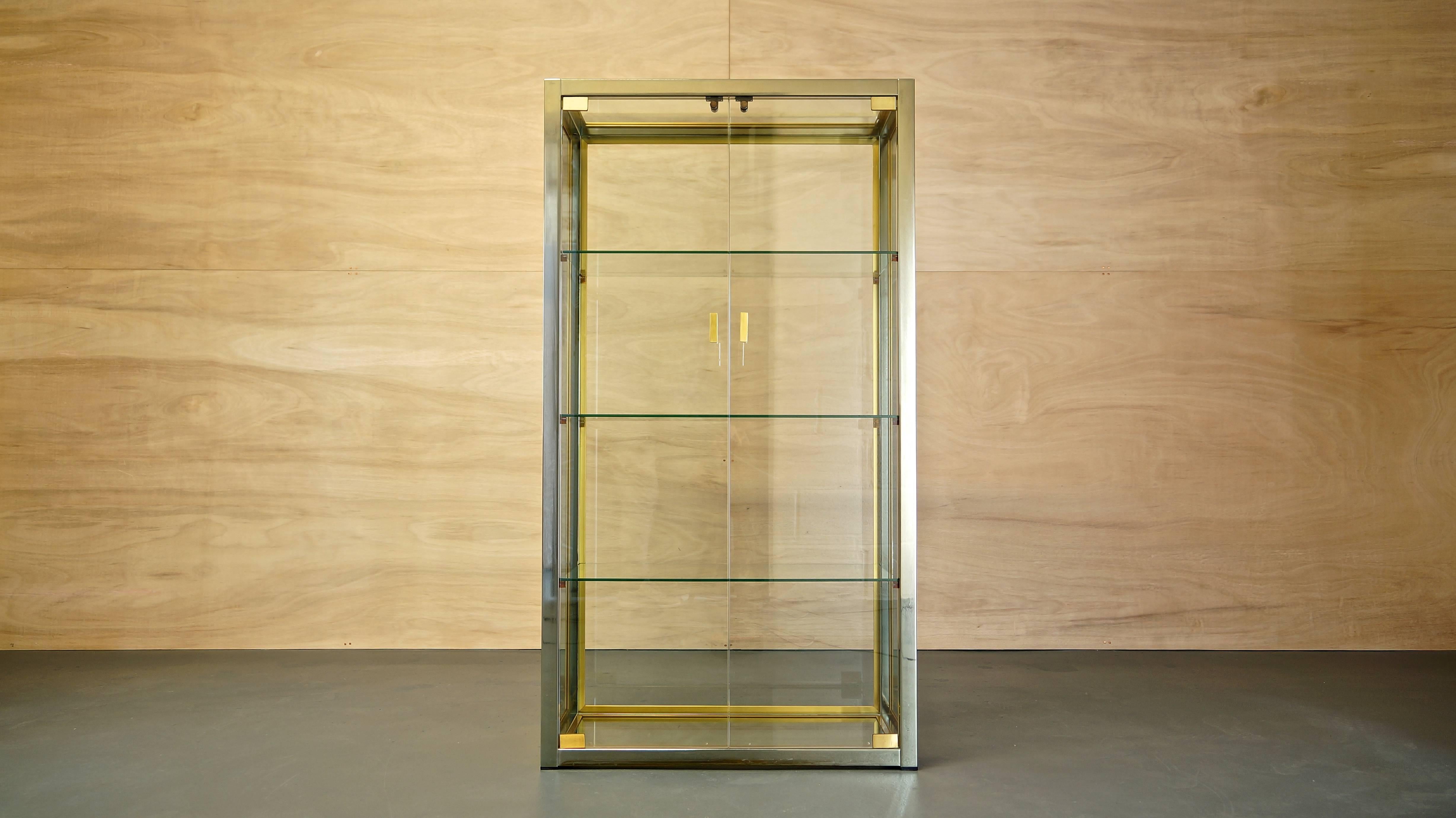 A highly prized and much sought after Italian display cabinet designed by Renato Zevi.

Produced in Italy, circa 1970s.

Construction consists of a high quality nickel-plated solid brass frame, surrounded by quality vintage green-edged glass and