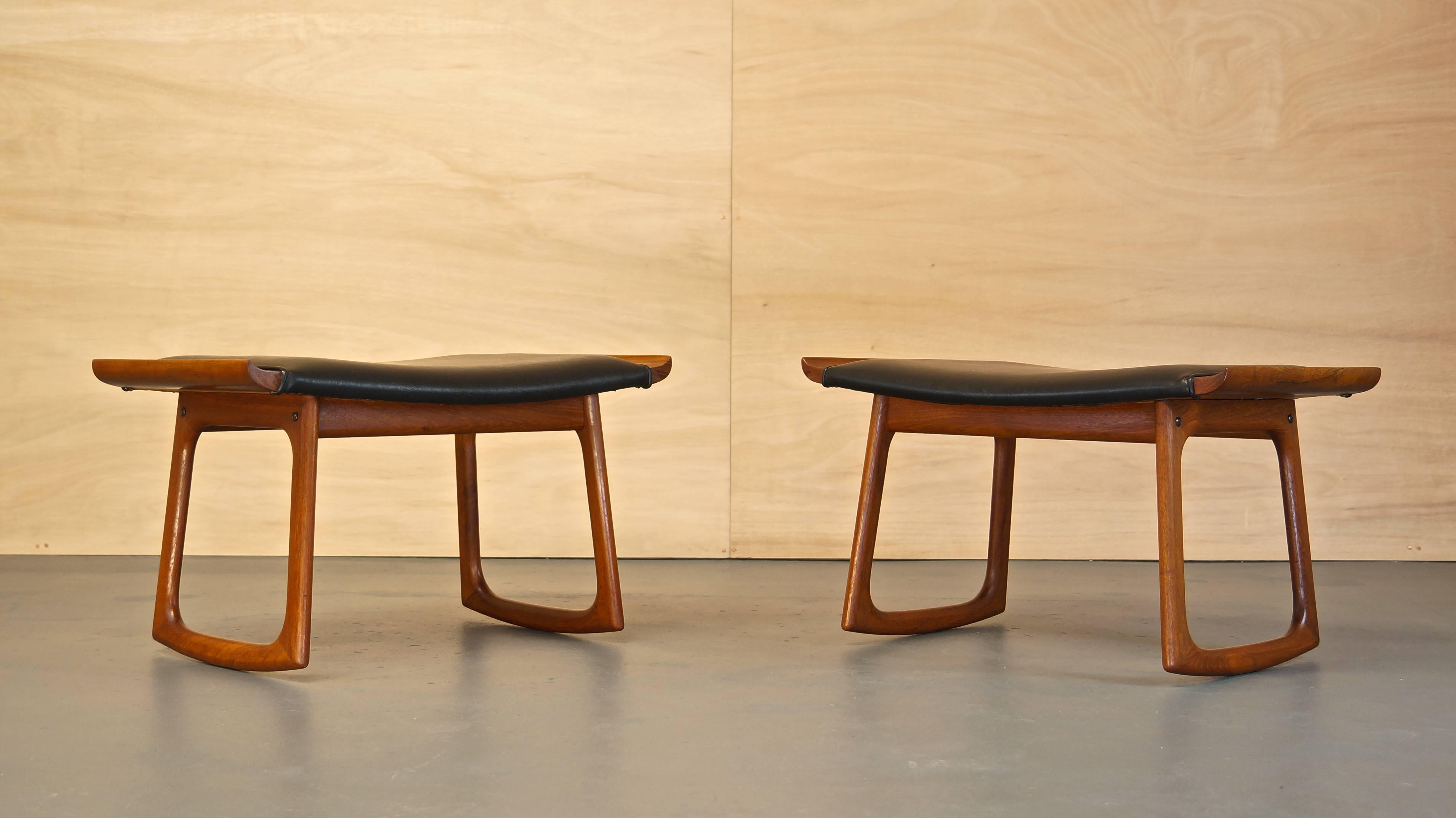 Pair of rare 1960s Mid-century Danish teak rocking ottomans/stools in the manner of Finn Juhl.

High quality construction and design throughout with its sculpted solid teak curved legs, winged seat edges and black naugahyde upholstery.

Metal