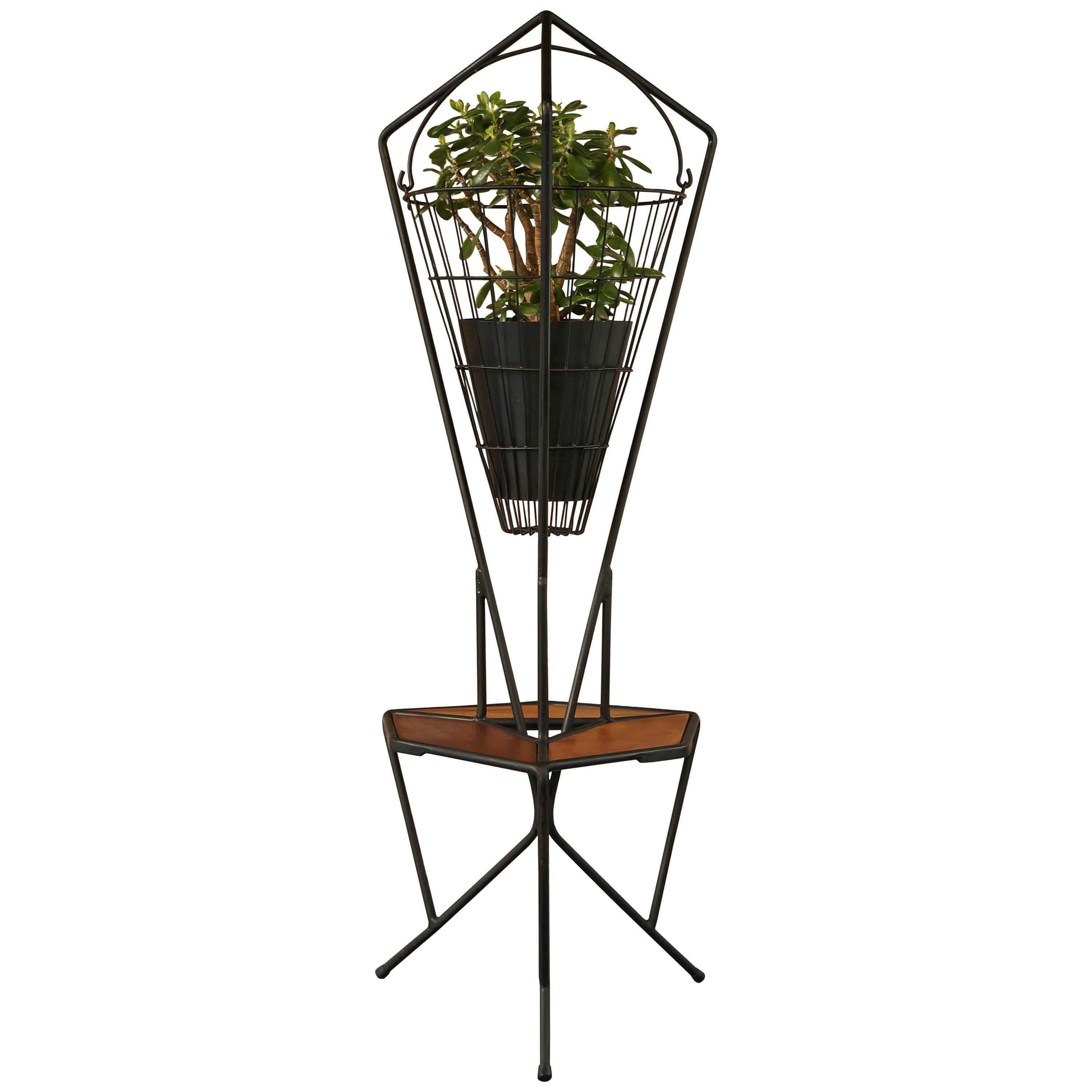 Unique midcentury vintage 1960s iron and teak hanging planter, plant stand, side table offered in excellent condition throughout. Dimensions: Height 132cm, height to shelf 38.5cm, width 48cm, depth 50cm.