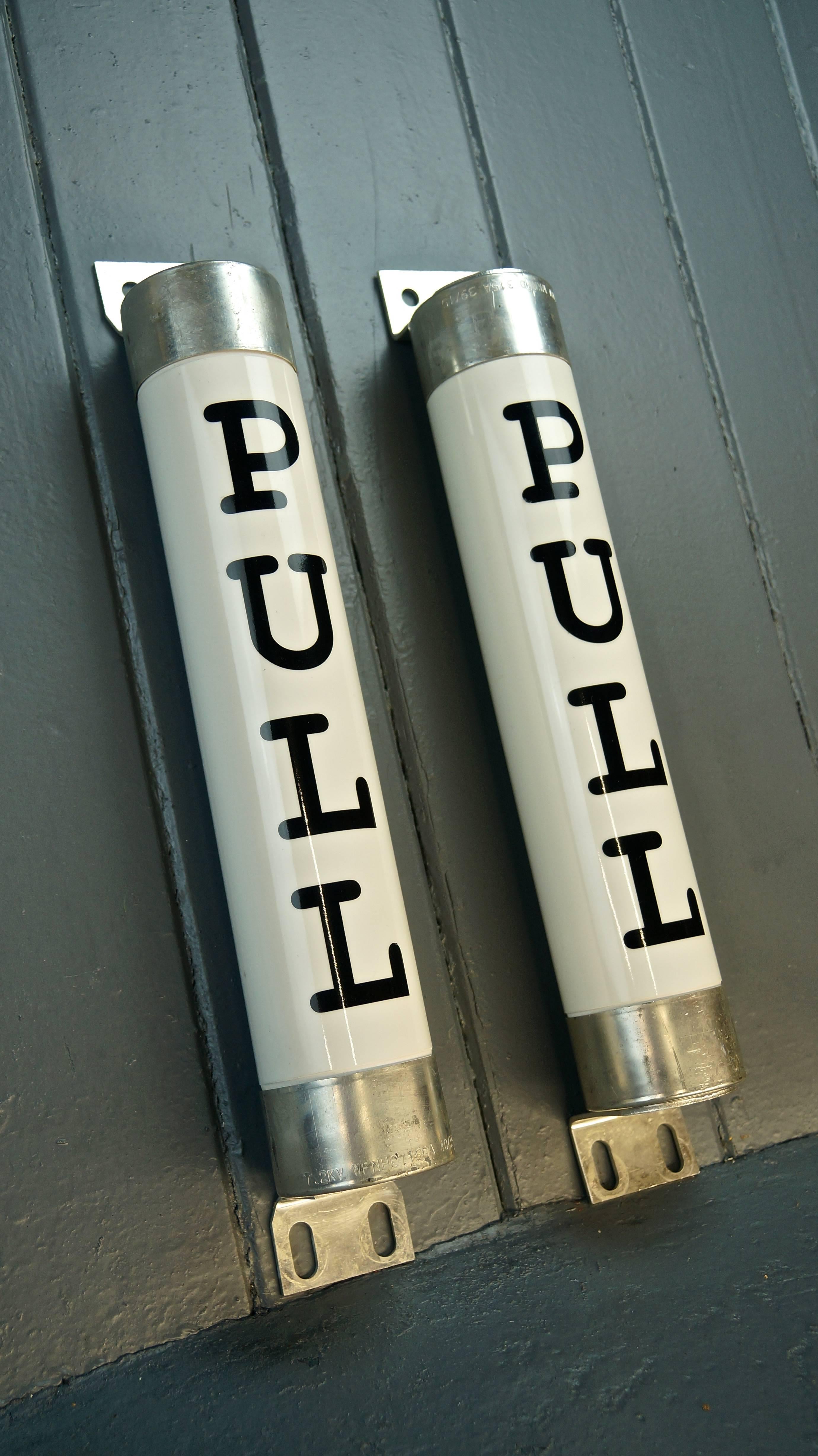 Pair of massive Industrial glazed porcelain 7.2 Kilovolt Fuses which have been converted into Door Handles 

A one off design salvaged from an old lighting factory

Measures: Height including brackets 49cm
Height not including brackets