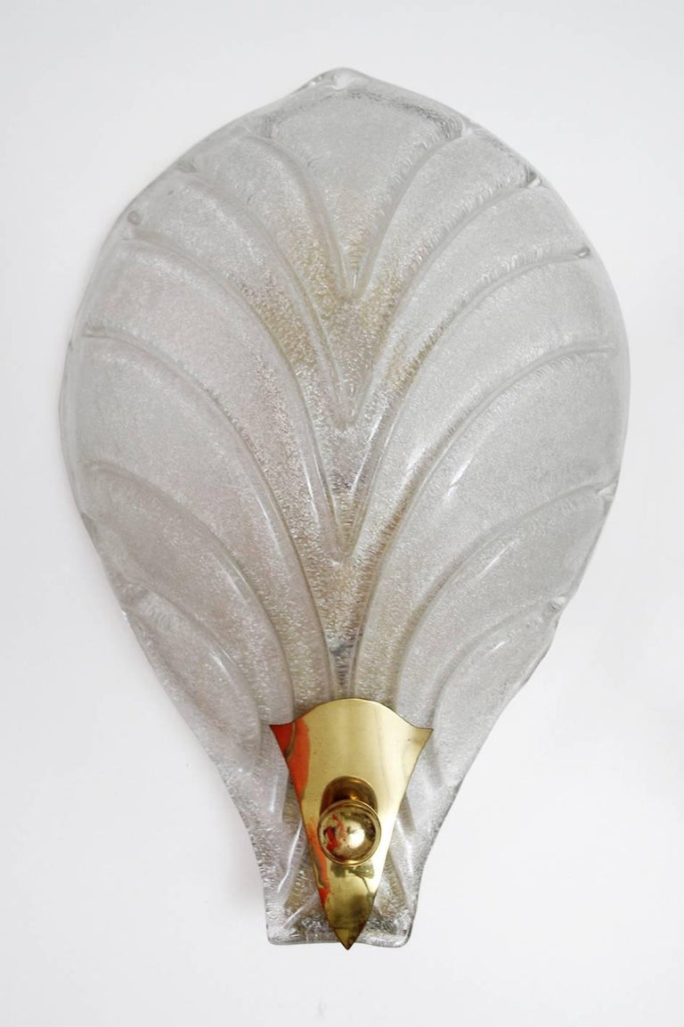 Set of five beautiful large Murano glass and brass palm leaf or shell sconces in a very good condition. 
Italy, 1960s.
Lamp sockets: 1