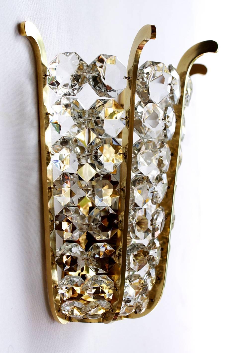 Pair of very beautiful crystal and brass sconces, Austria, 1950s.

Measures: 
Height: 8.85 In
Width: 9.05 In
Depth: 4.6 In
Lamp sockets: 1x E27 (E26).