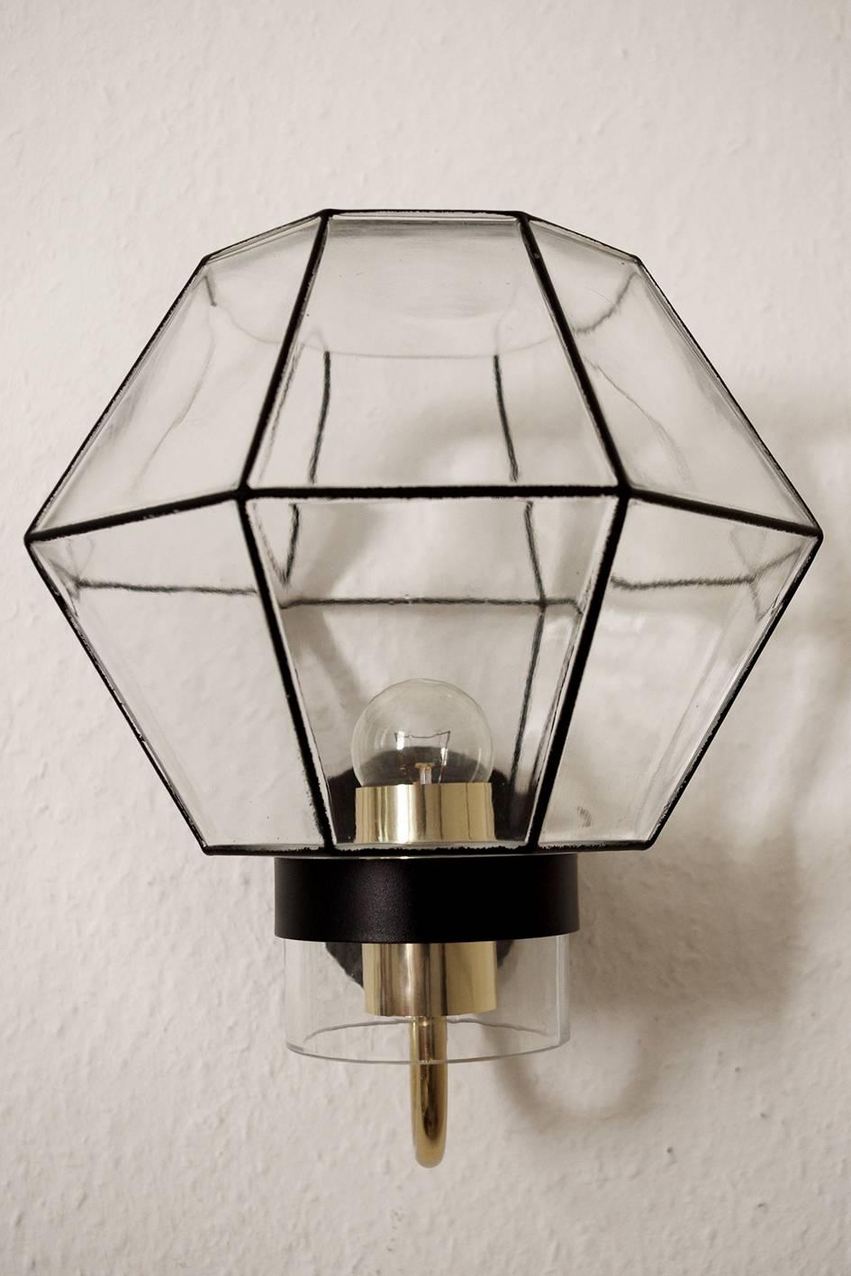 One of... large geometric crystal (topas) glass, brass and iron wall light sconce. 
Germany, 1960s.
Lamp sockets: 1x E27 (US E26)
