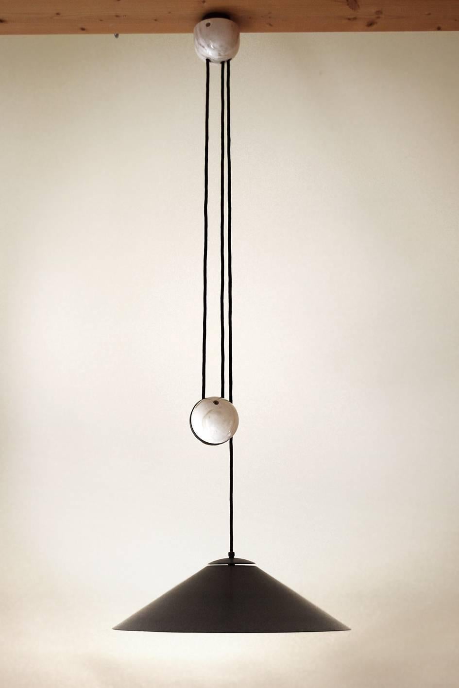 Large brass and marble adjustable counterweight pendant. 
Germany, 1960s.
Solid brass schade with beautiful patina. The outside is burnished and the inside is brushed.
Measurements: Diameter: 19.5 in, Height (lampshade): 6.2 in;
Lamp sockets: 2x E27