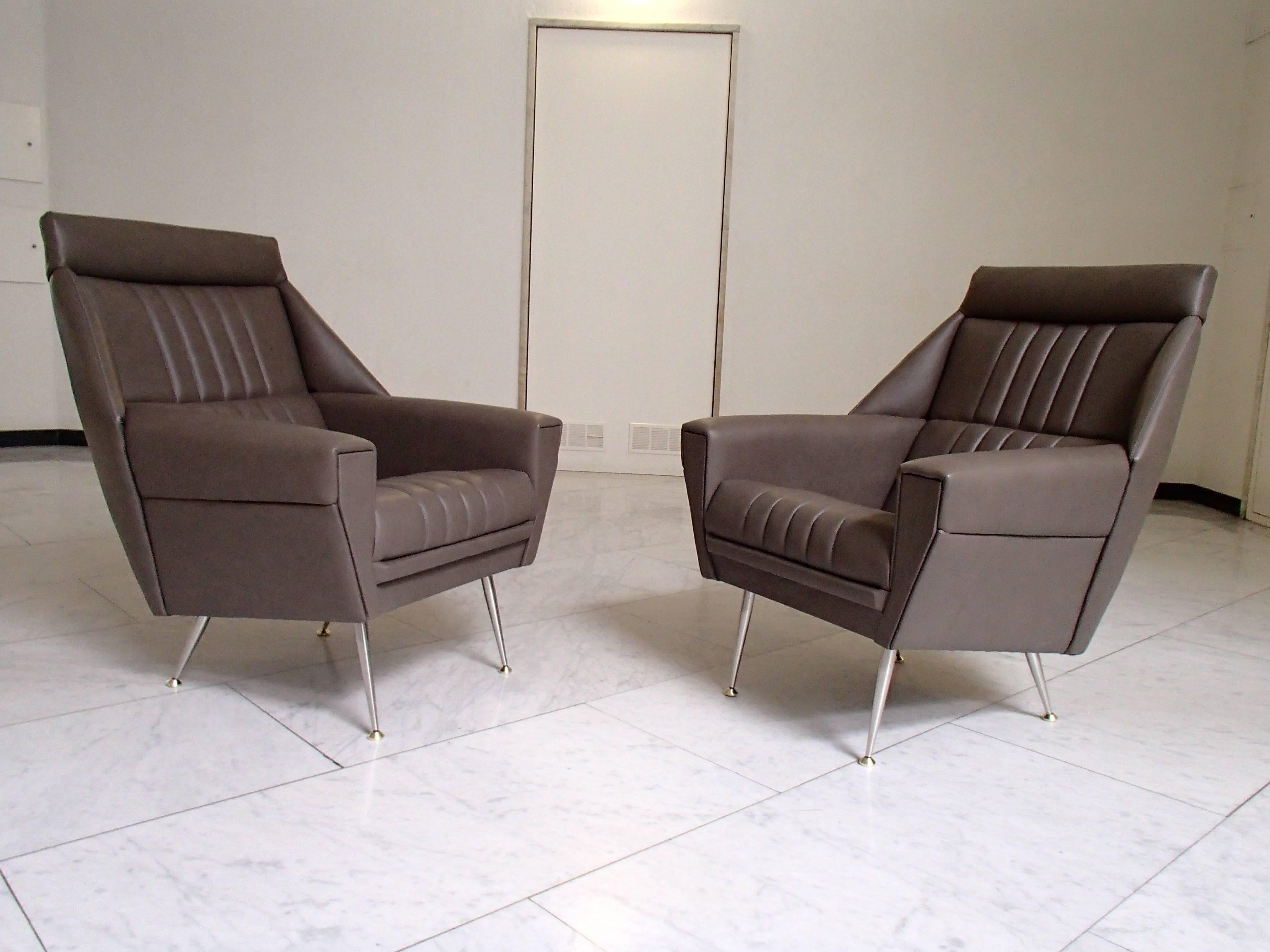 Completely re upholstered and recovered with grey greenish leather brass legs.