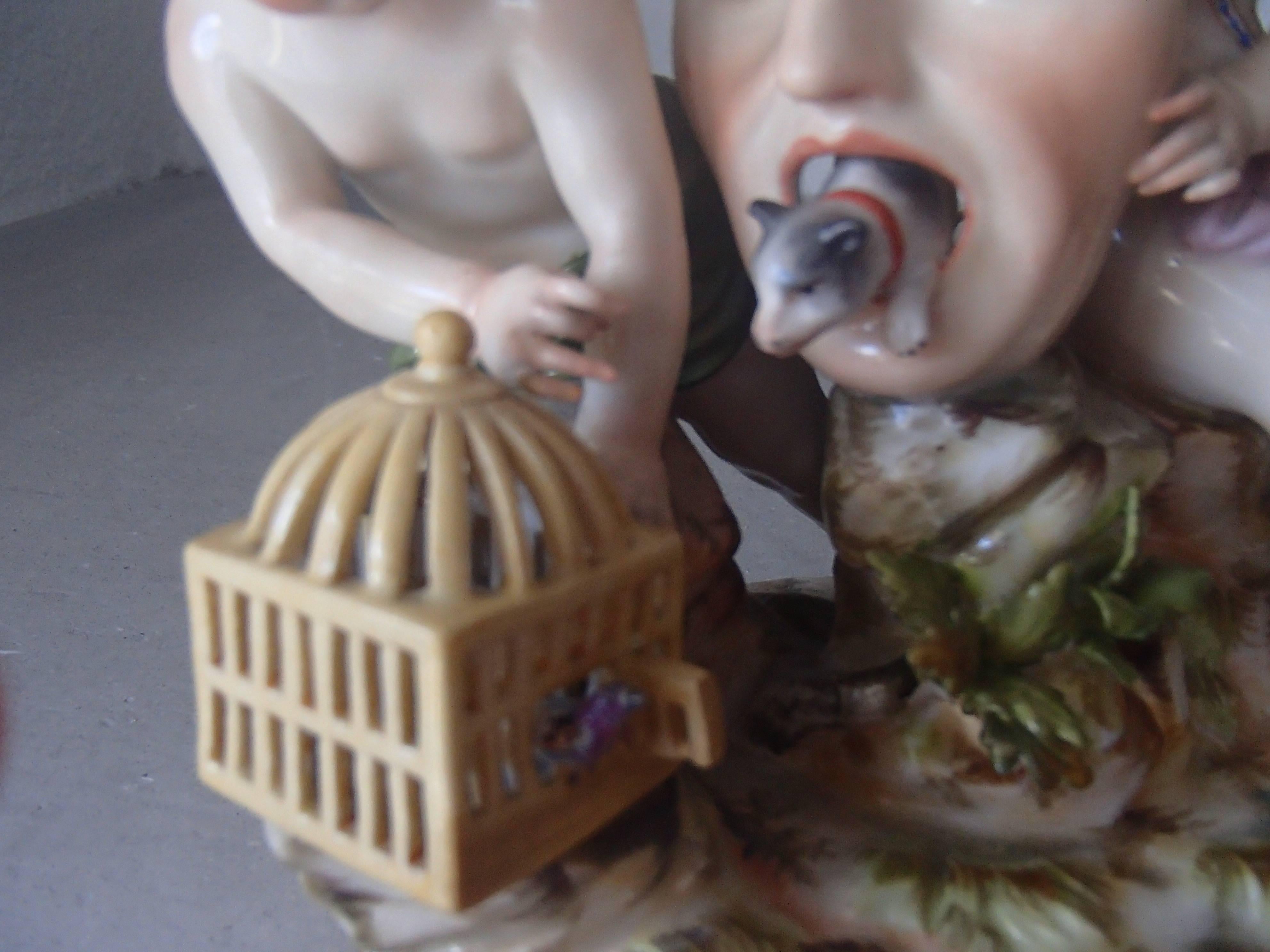 Rococo 19th Century Meissen Figurines Two Putts Holding a Mask and Birdcage For Sale