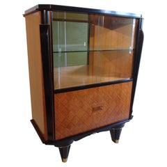 vitrine with very sophisticated inlay on the doors and brass look