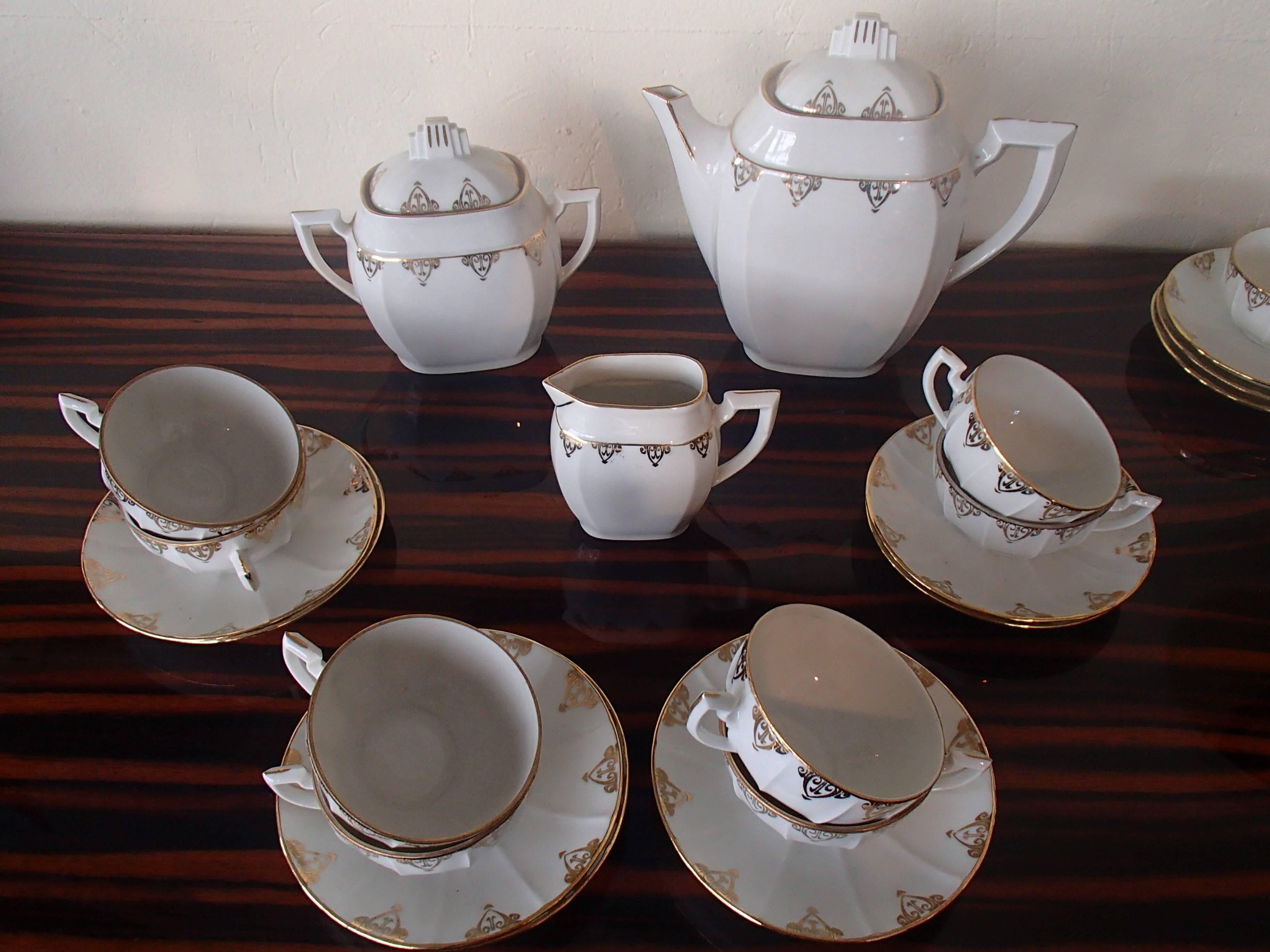 Very elegant tea set for eight persons complete with teapot crème and sugar bowl plus four sauces and one cup. French M&S with golden Art Nouveau pattern.