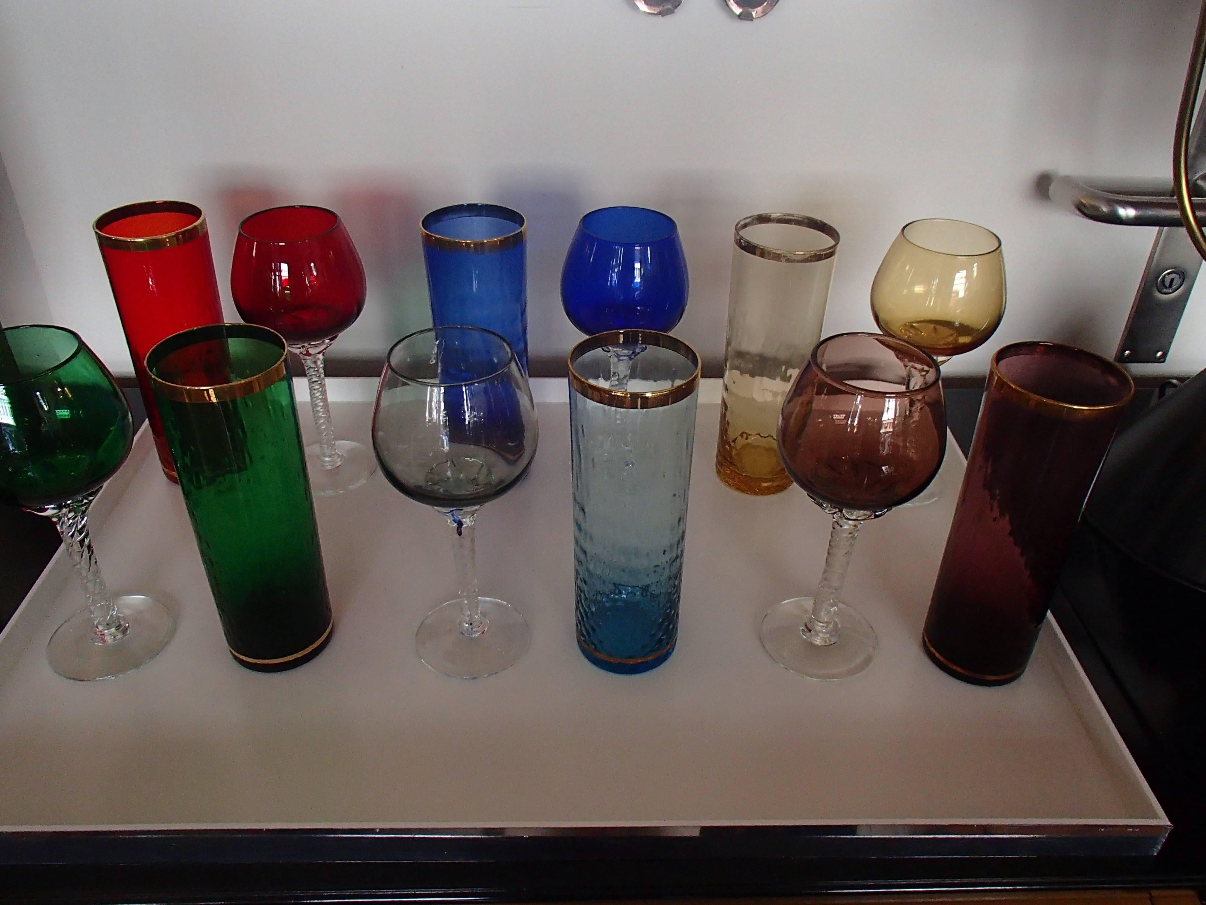 Colorful set of six wine and six water drinking glasses in red blue green violet yellow and light blue. No chips or cracks just some fading of the golden.
