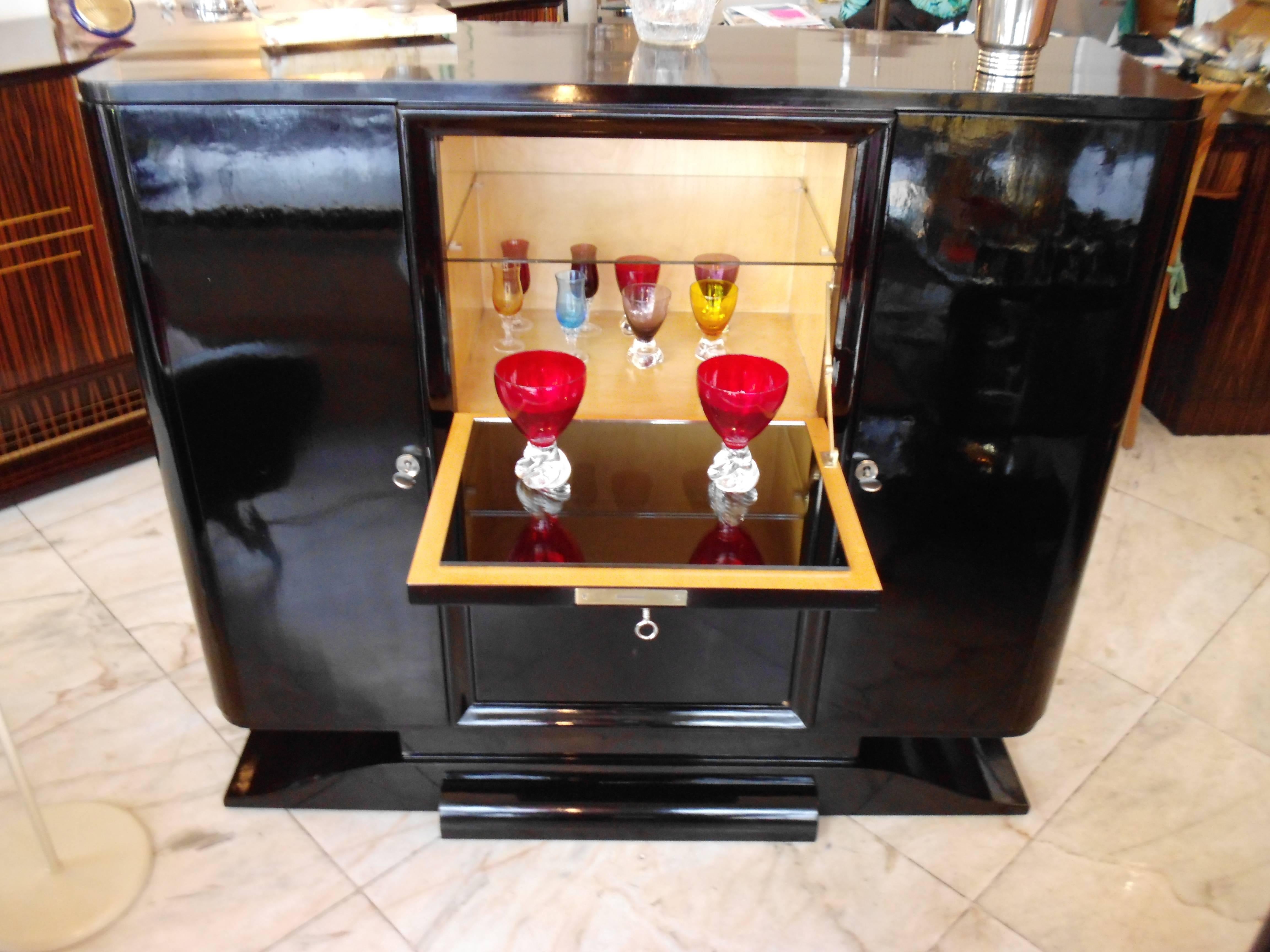Art Deco drinking cabinet bar black with 16 bottle compartments.
Lacquered with black shellac.