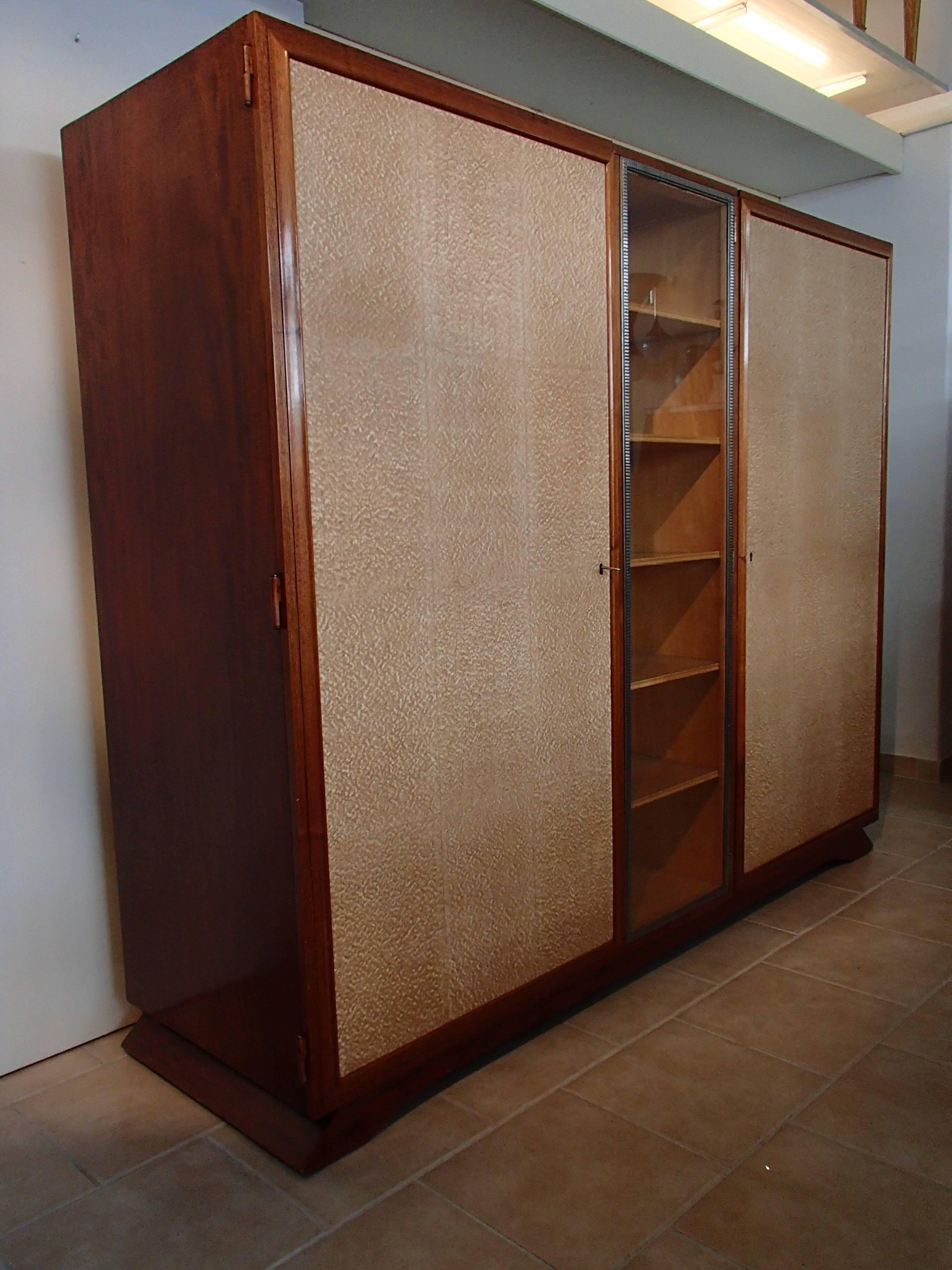 Art Deco Wardrobe full mahogany with pergament like doors and wrought iron 
restored. Can be dismantled for transport.
