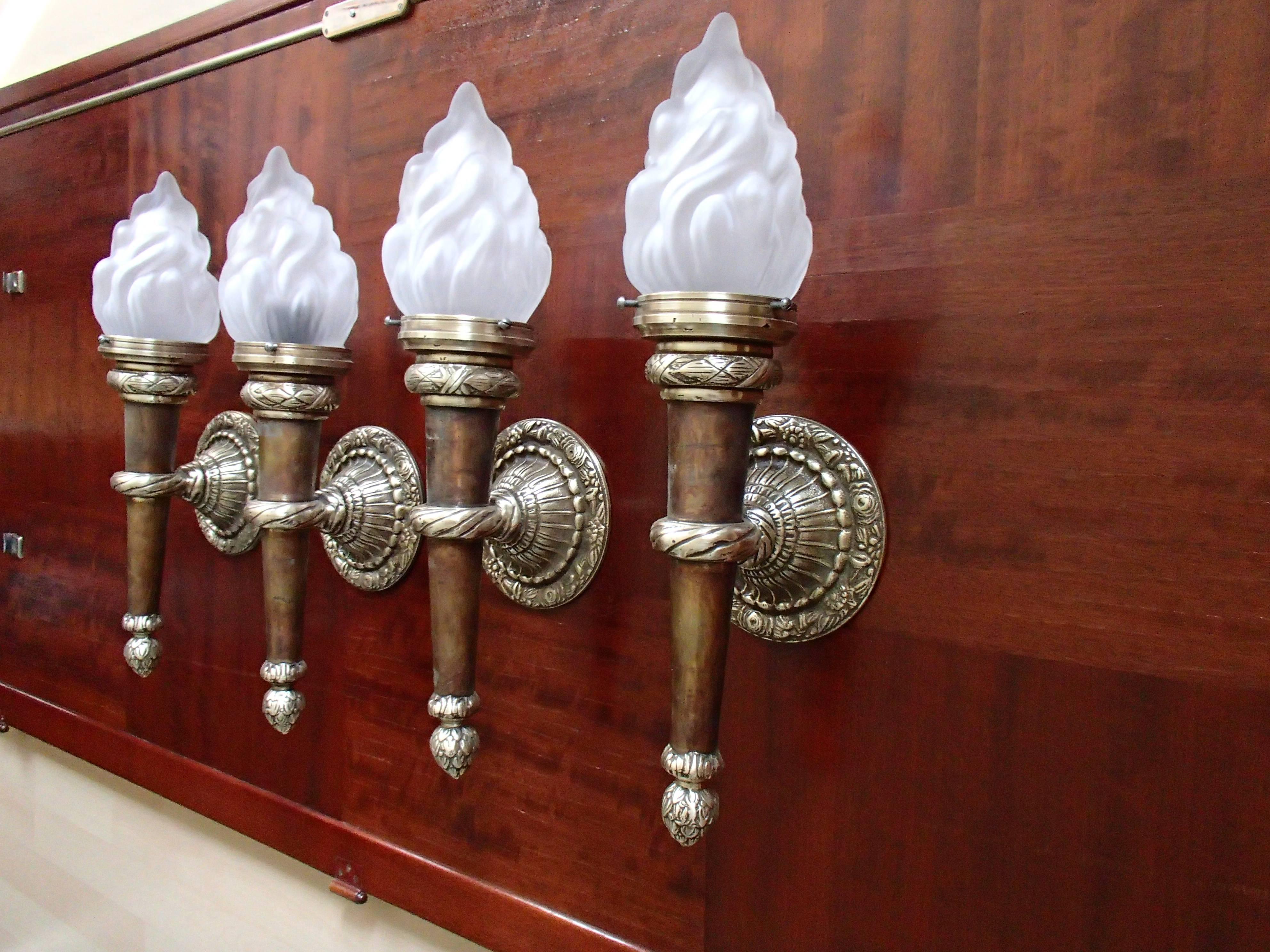 Four huge walllights torches with flame glass.