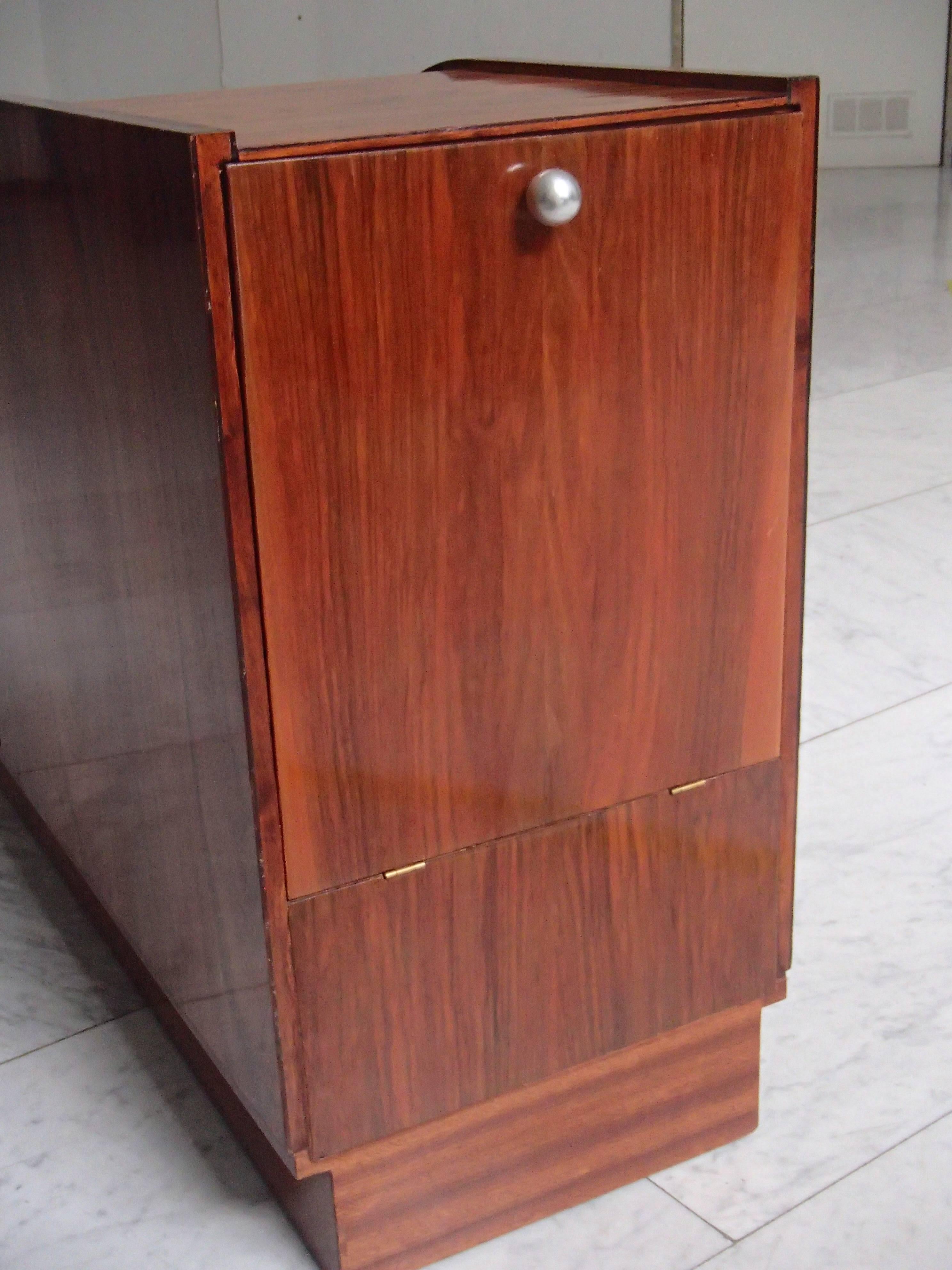 Art Deco rosewood bar with mother-of-pearl inlays and chrome elements.