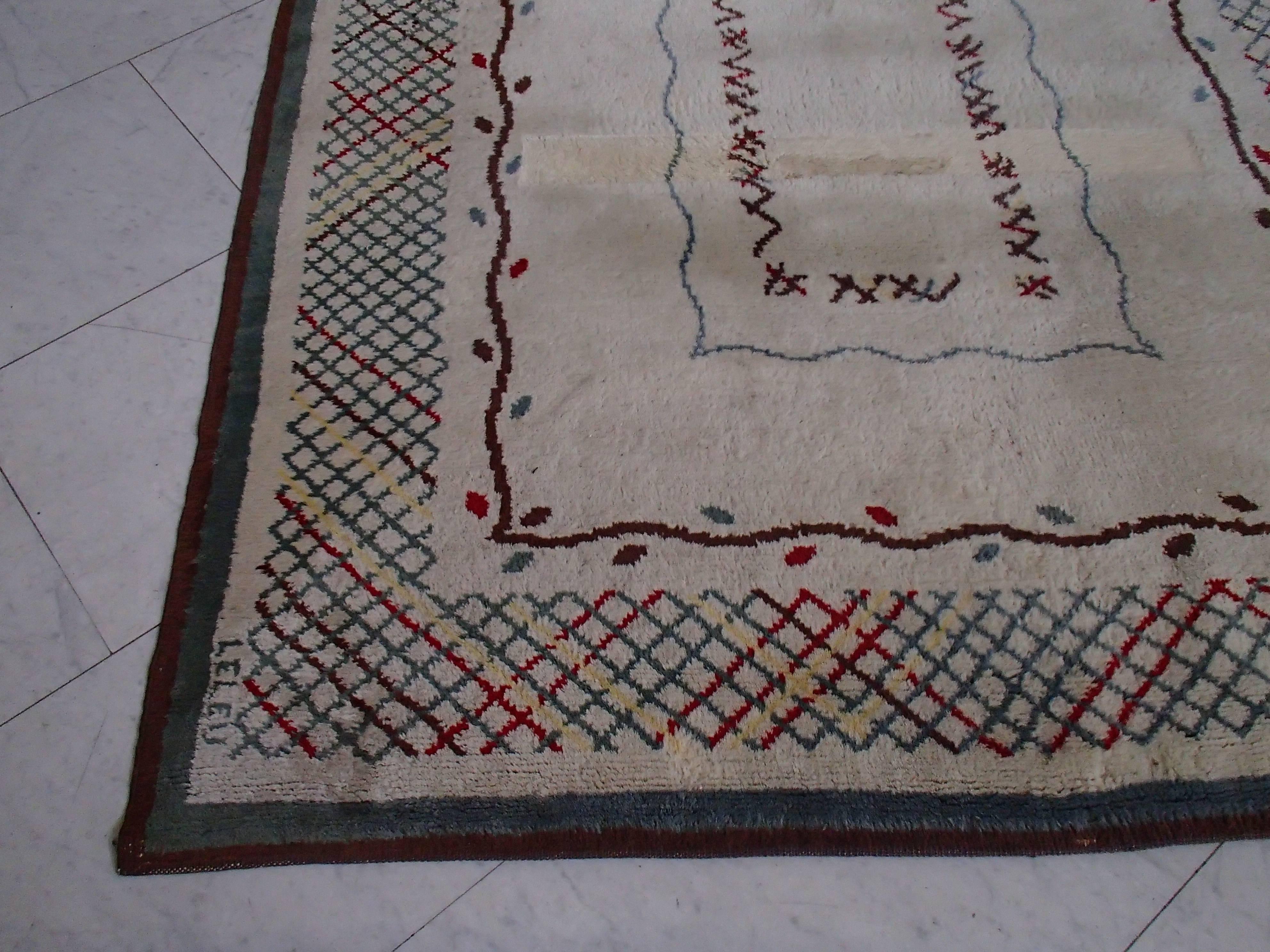 Midcentury carpet signed by Leleu. The marks on the carpet are from a table standing on it.