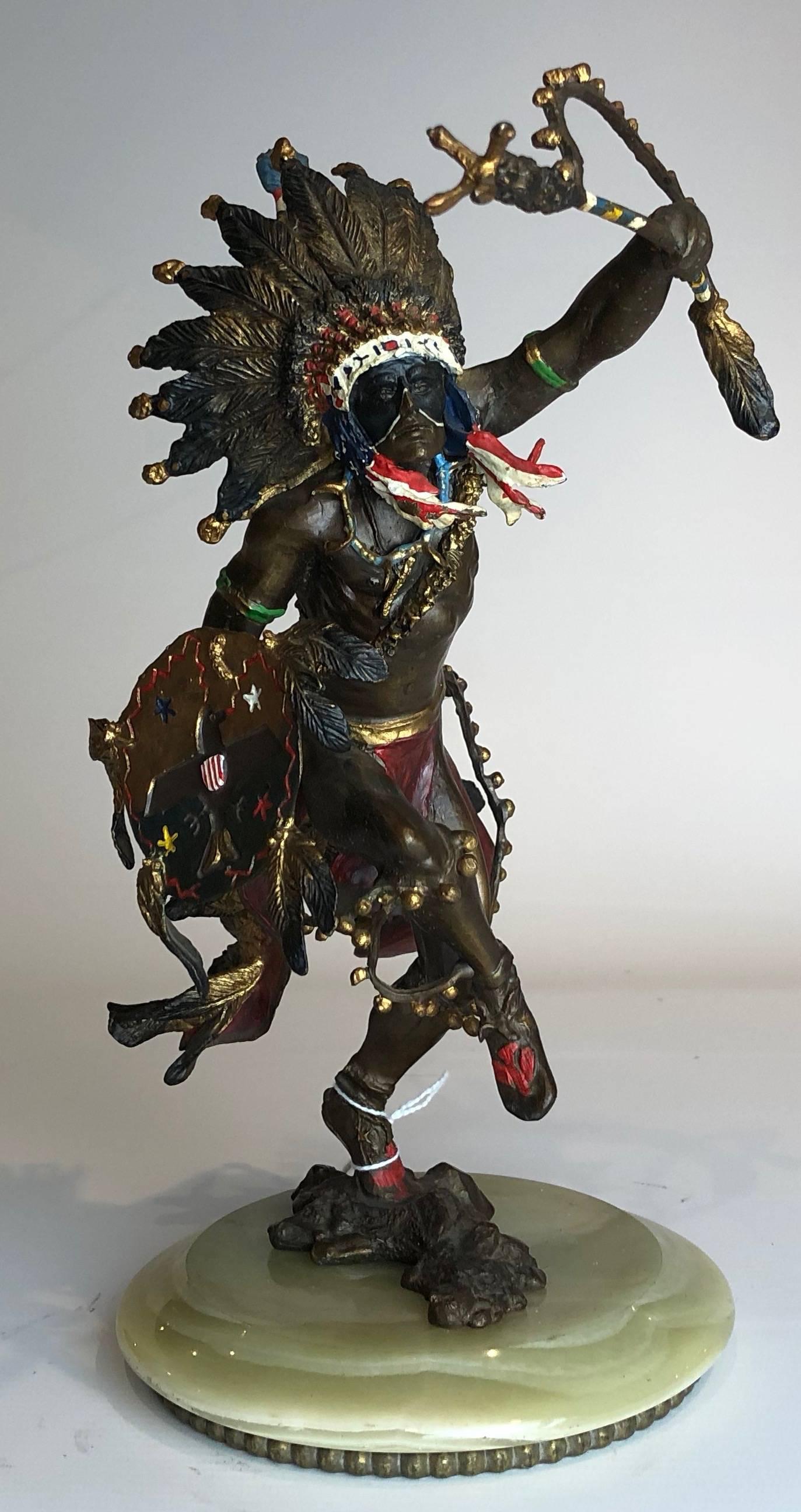 An excellent example of an early 20th century Austrian polychromed and patinated bronze sculpture depicting a Native American Indian running into battle

Standing 11