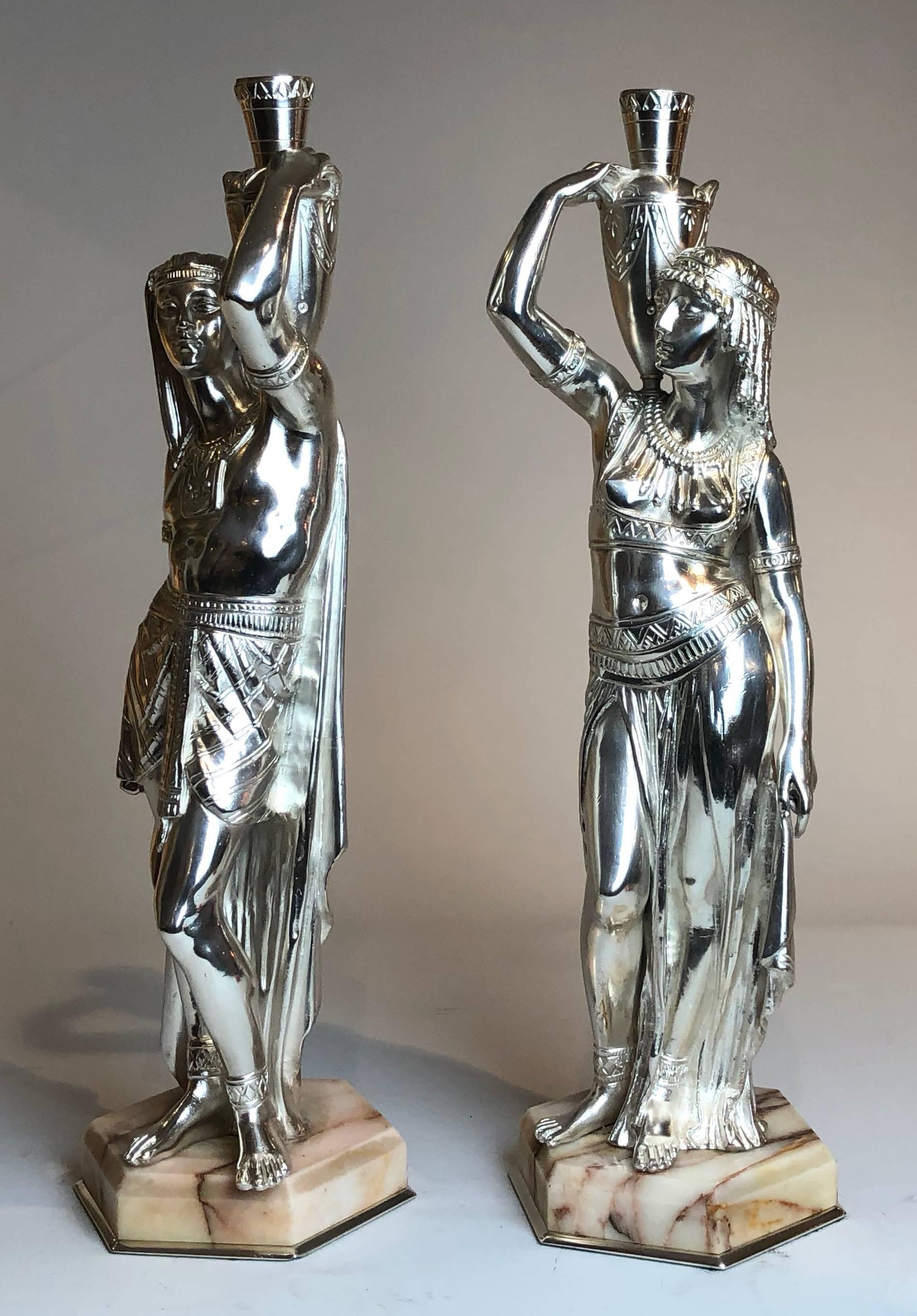 Stunning pair of silver bronze Egyptian figures. Beautifully cast from the period of the second Empire revival in France, with marble base finished with silver bronze. 


France, circa 1880.
