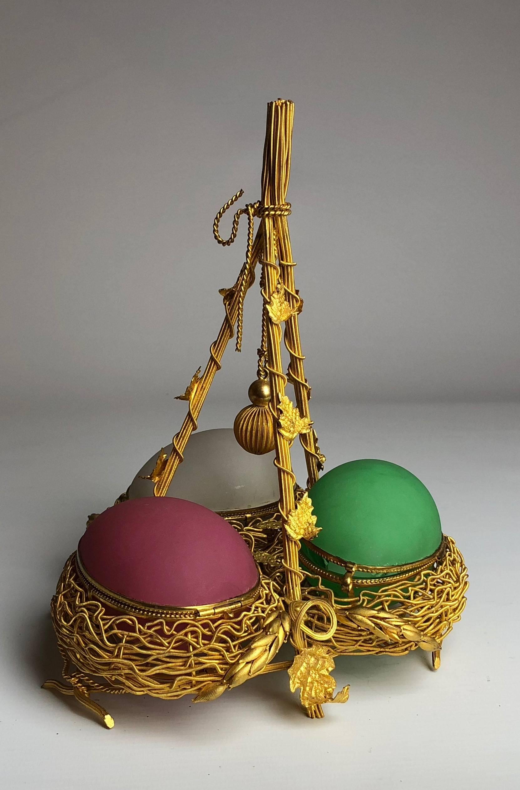 This fantastic piece of Palais Royale would be best described as a ladies companion, each of the eggs opens, one is left empty to place rings etc. in, another is fitted with a small sewing set and the final egg holds a perfume bottle.

France,
