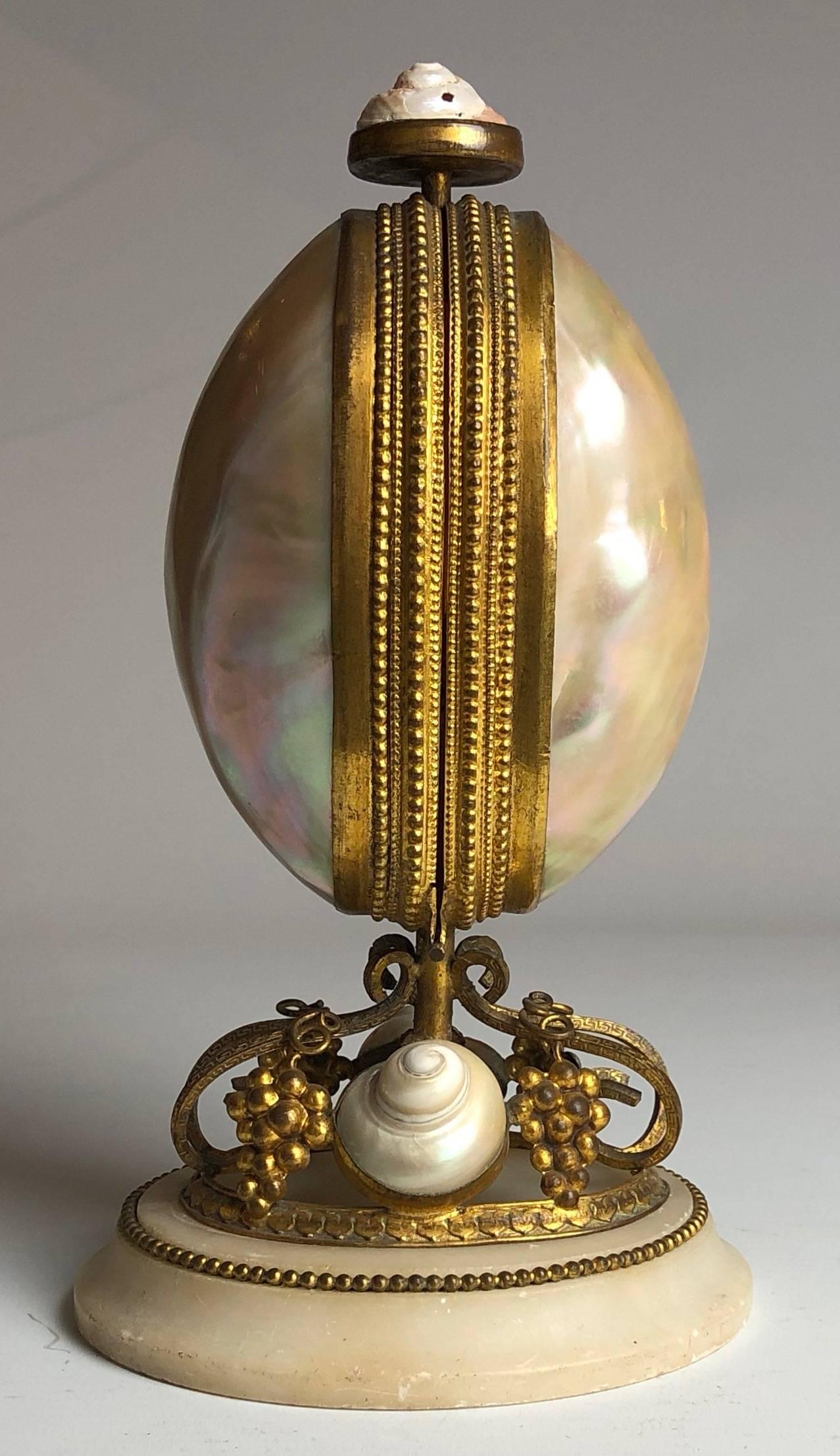A very fine example of a French 19th century shell and gilt bronze perfume bottle holder of egg shape and with mechanical opening.

Please note two of the scent bottle are missing,

France, circa 1880.