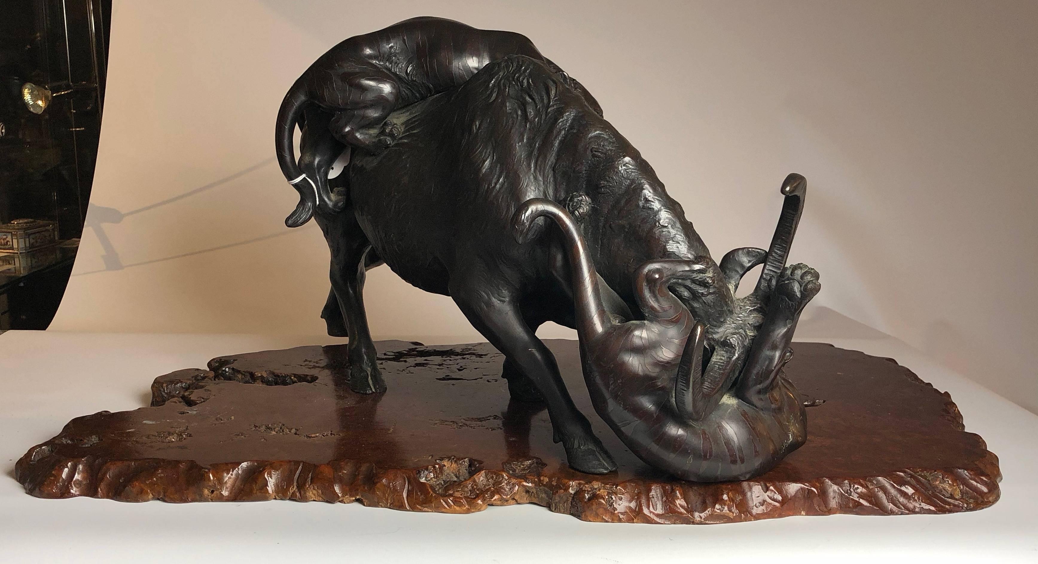 This very impressive Japanese bronze depicting a Buffalo being attacjked by a pair of tigers.  Sat on a naturalistic wood base.
The bronze itself measures 21