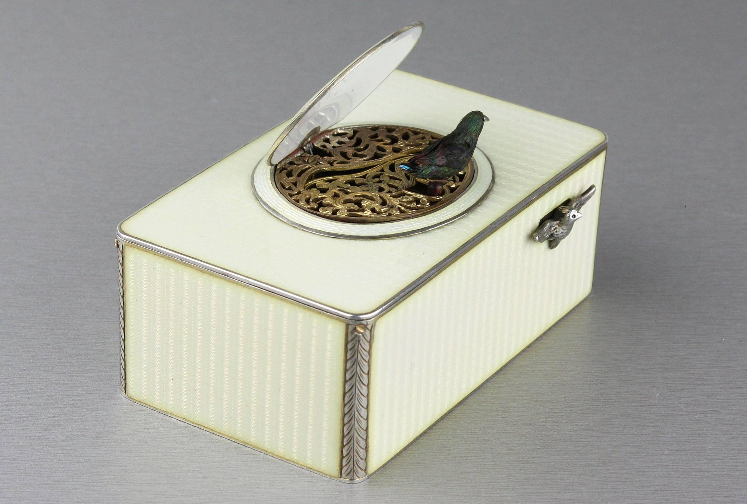 A luxurious vintage silver and full cream guilloche enamel singing bird box.
 
Retailed by Nissel & Sikora, of Austria,
 
French,
 
circa 1925.
 
Going barrel movement.
 
The cream of the crop.
 
When wound and the bird-form start/stop